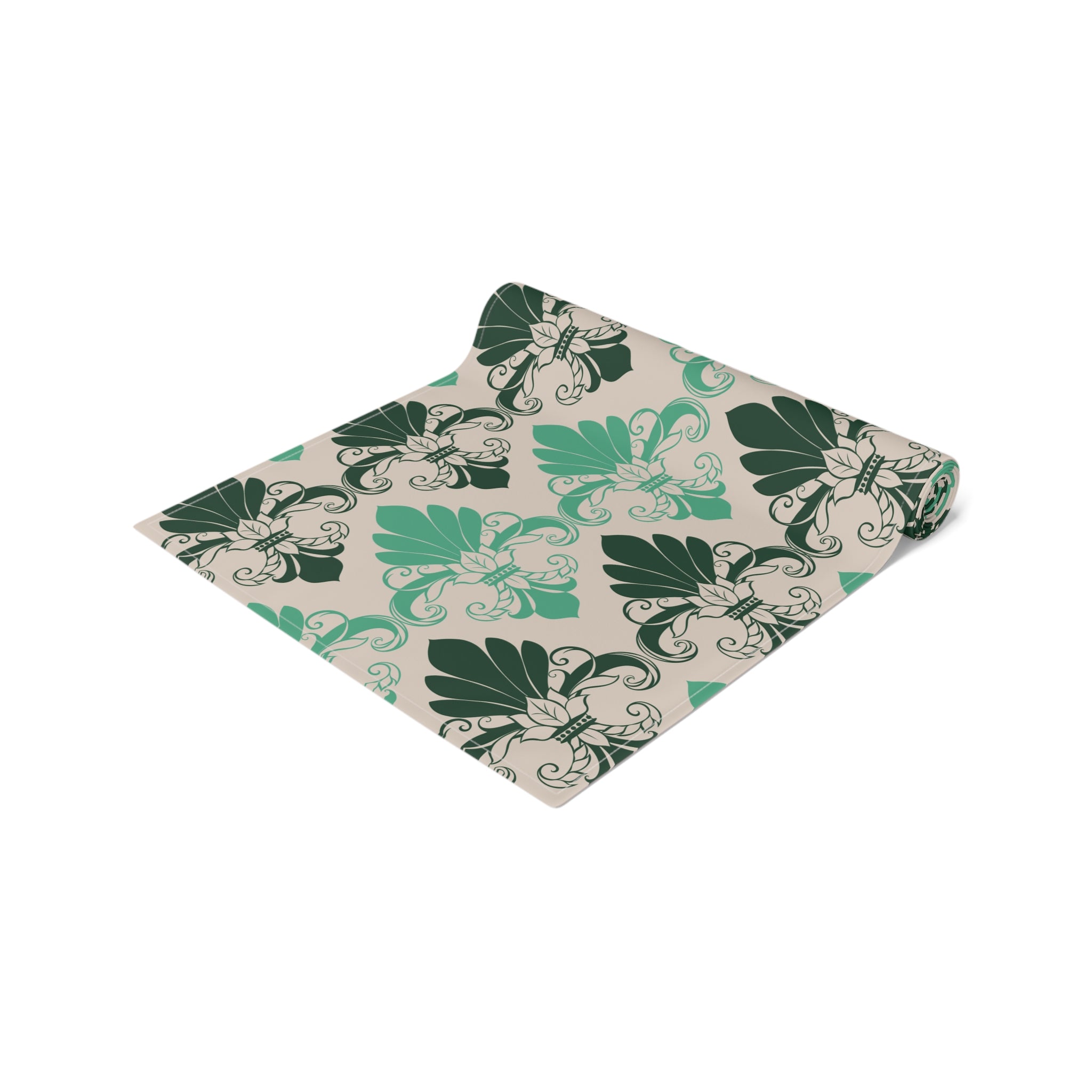 Folded fabric with green leaf pattern on a beige background