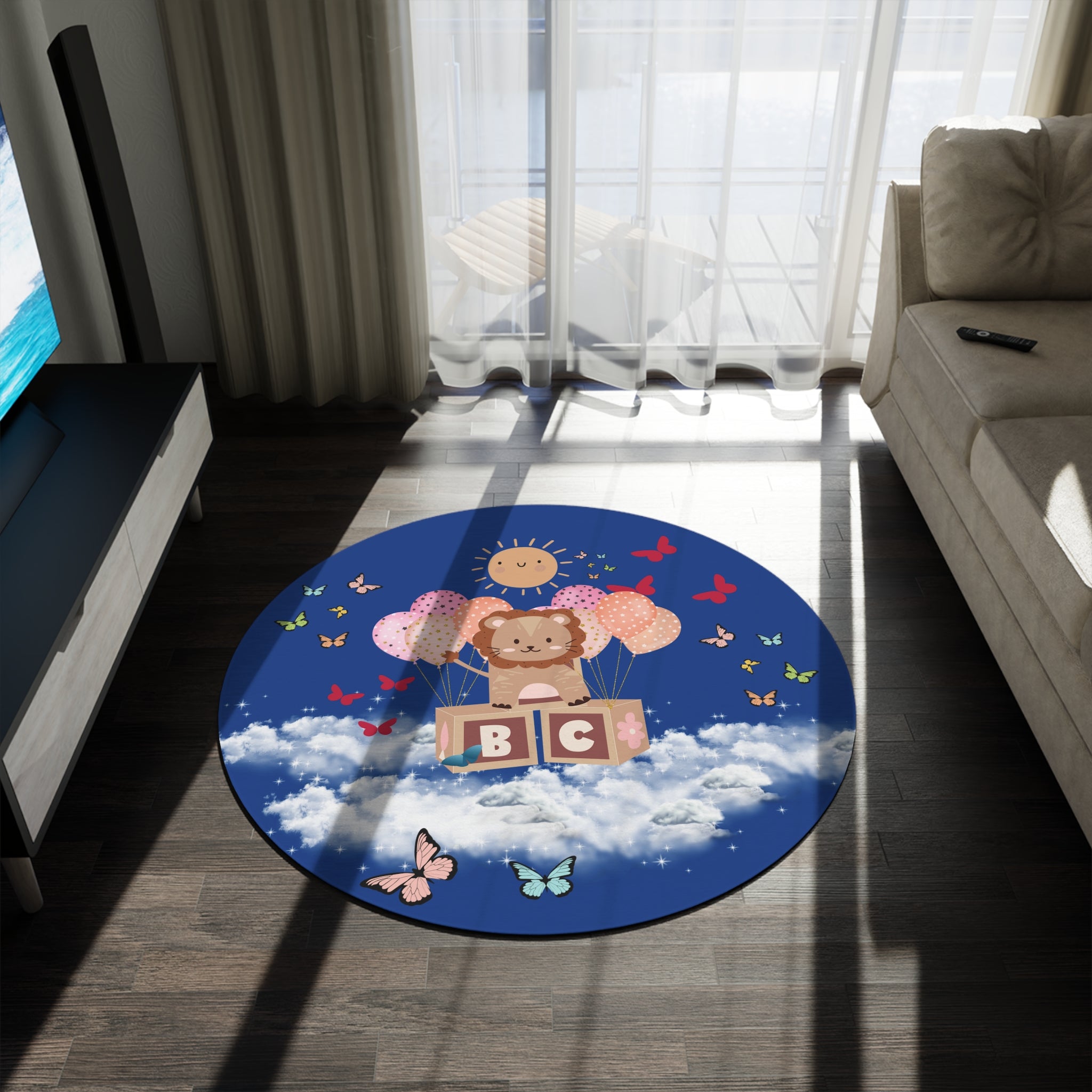 Round children's rug with cartoon design on a wooden floor in a living room.