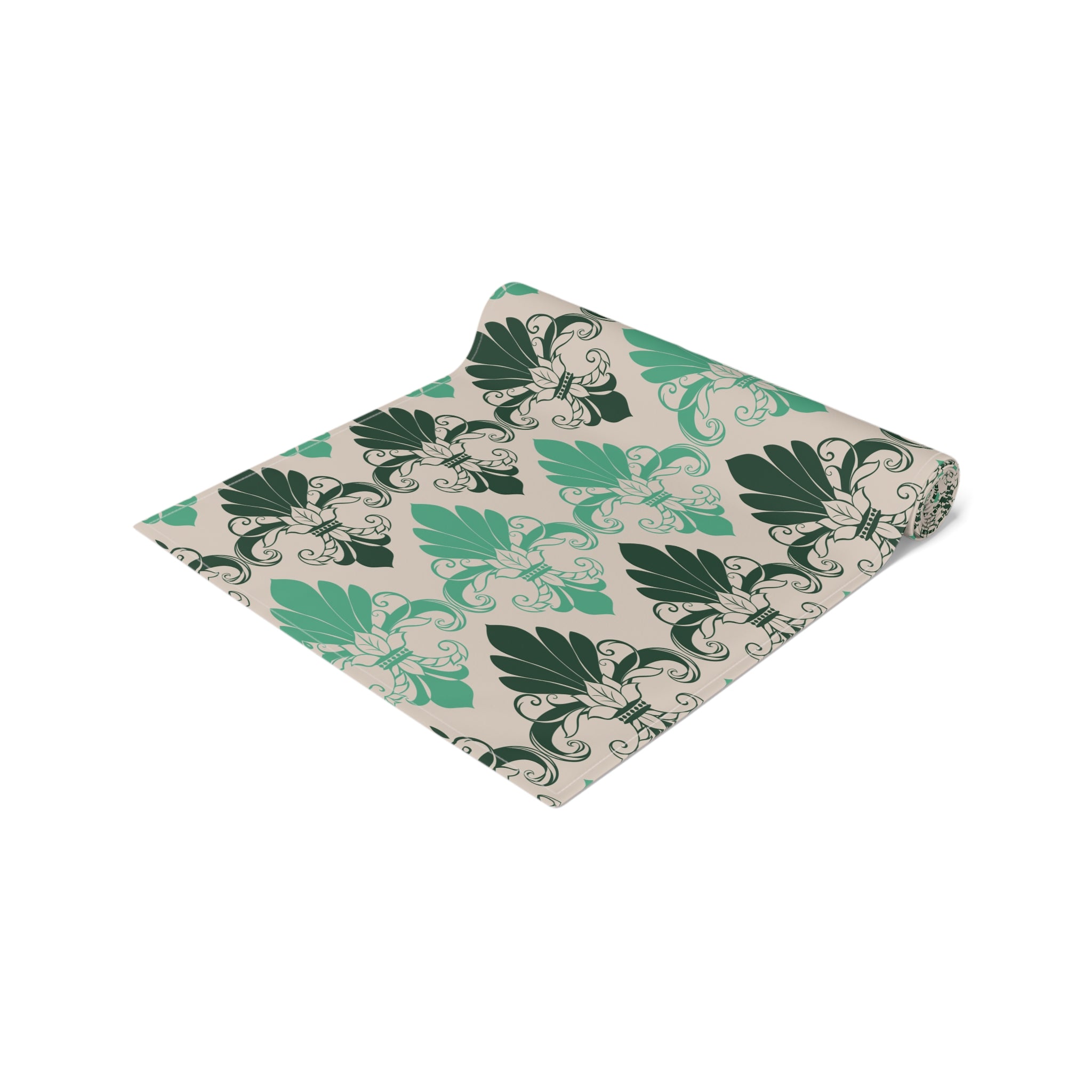 Folded fabric with green leaf pattern on a white background