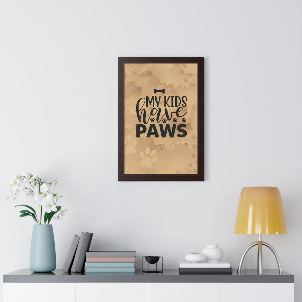 Framed print with 'My kids have paws' text on a wall above a desk with decor items.