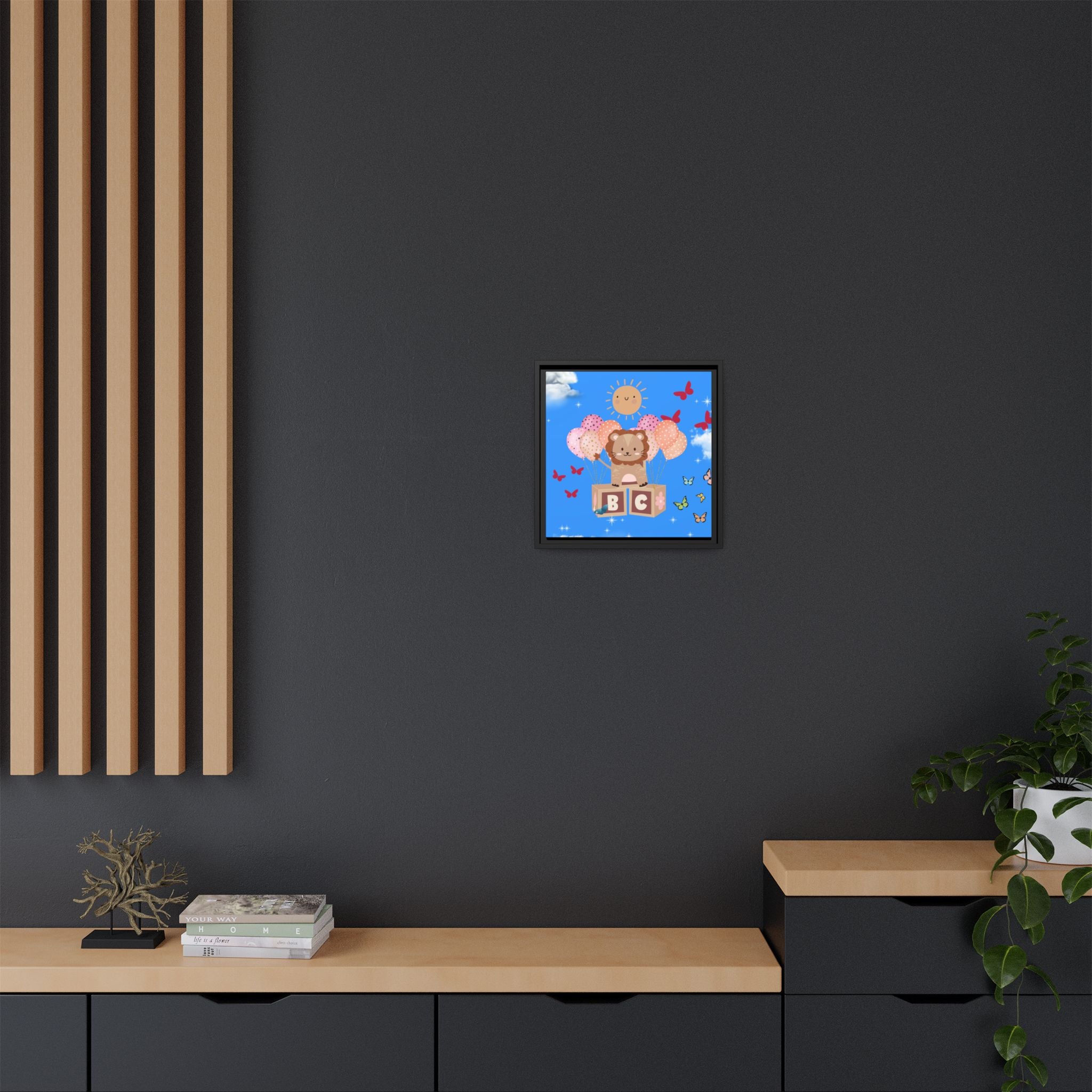 Framed artwork of a cartoon bear with a blue sky background on a dark gray wall.