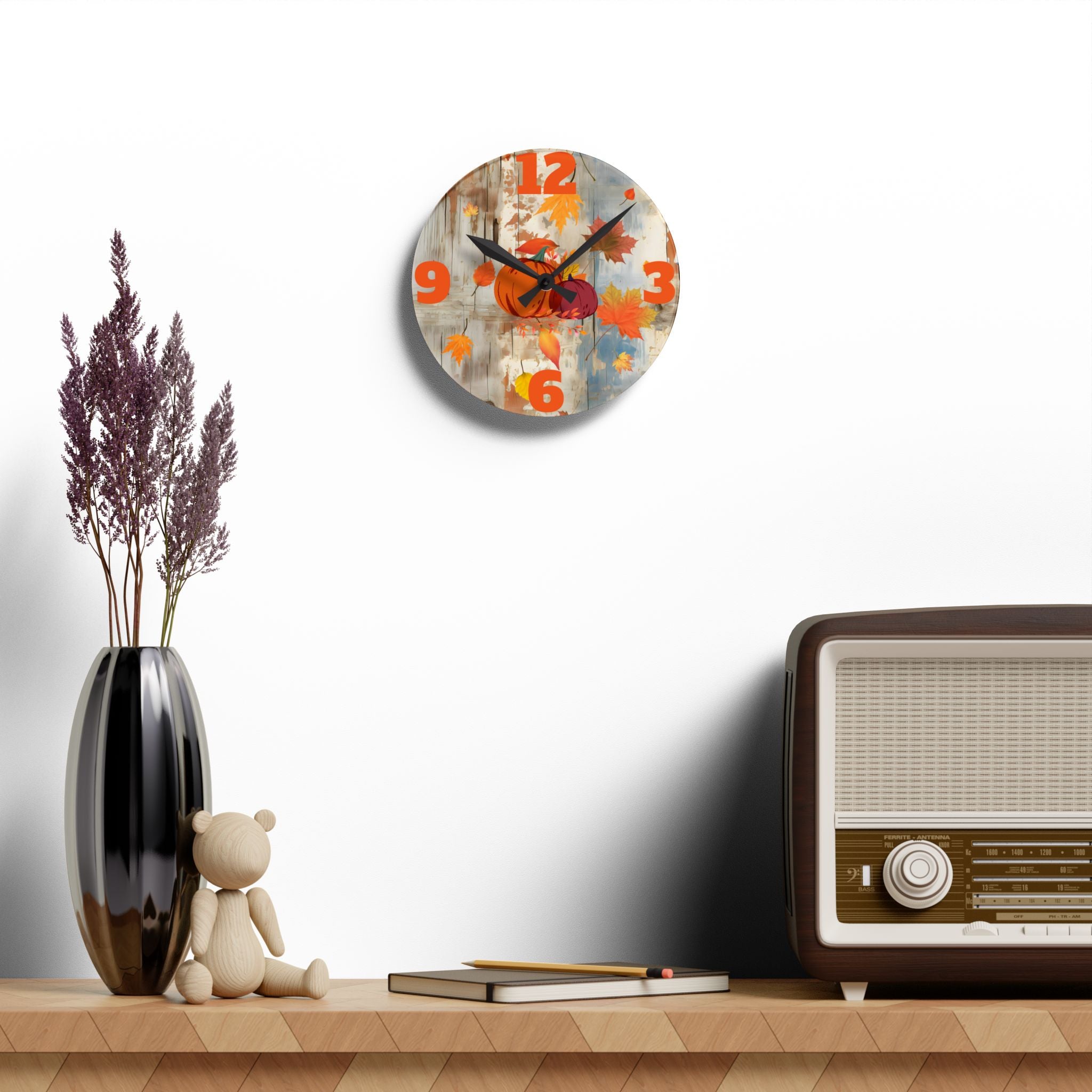 Decorative wall clock with colorful design on a shelf with a vase, teddy bear, and vintage radio.