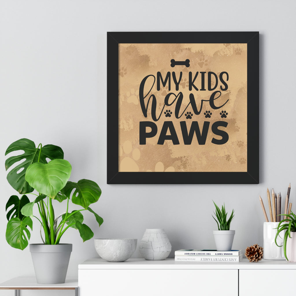 Framed artwork with 'My kids have paws' text on a wall above a white cabinet with decorative items.