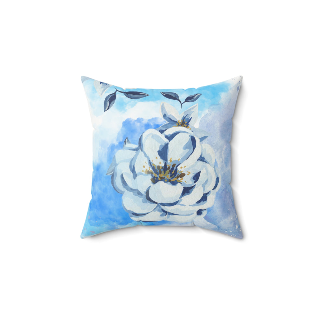 Floral pillow with blue and white design on a white background