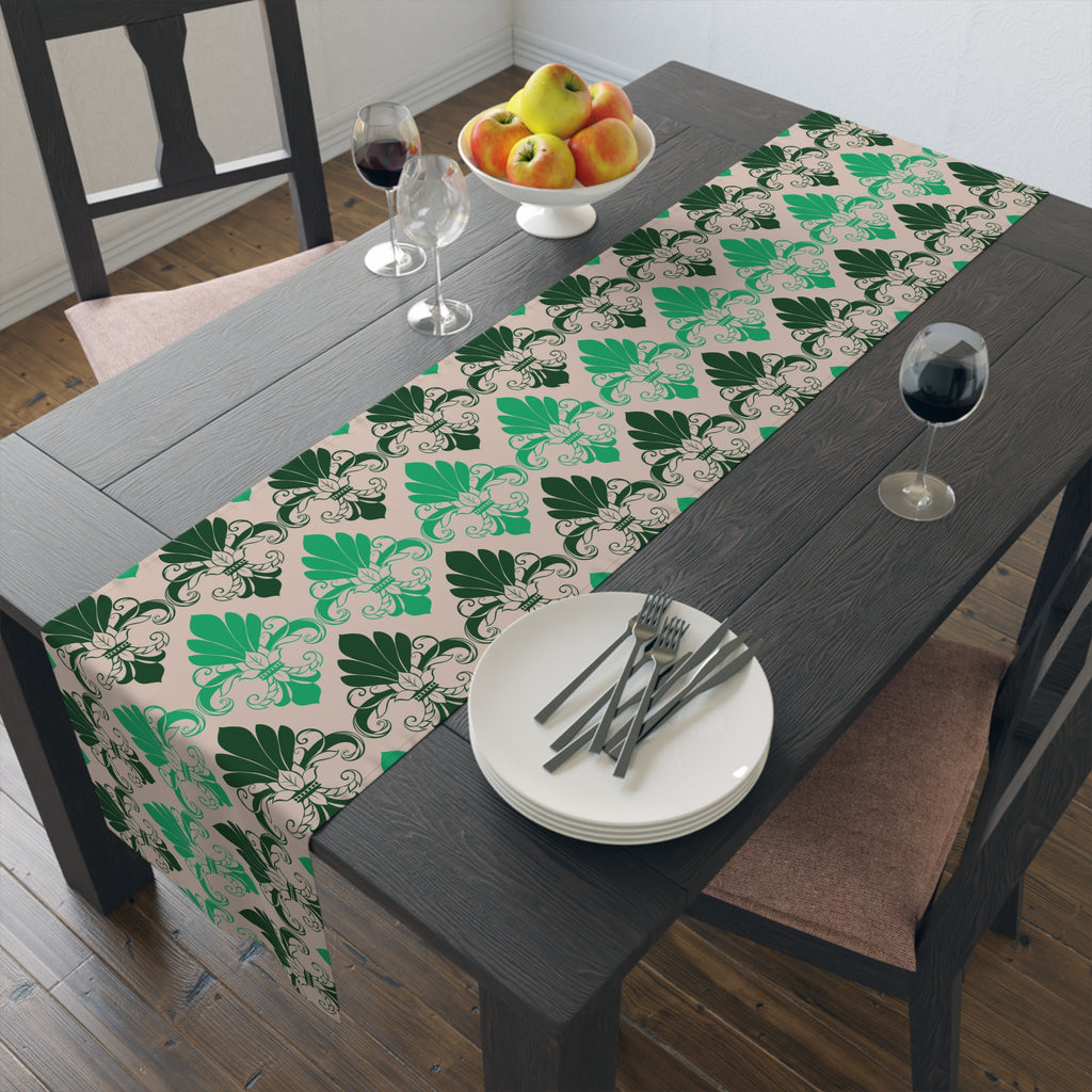 Dining table with a green and beige patterned table runner, plates, forks, and apples.