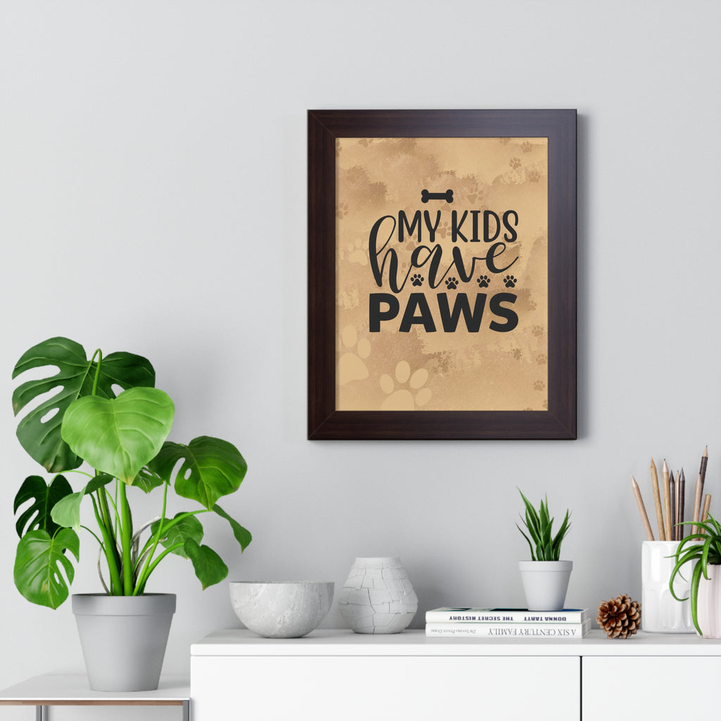 Framed print with 'My kids have paws' text on a wall above a white cabinet with plants and decor.