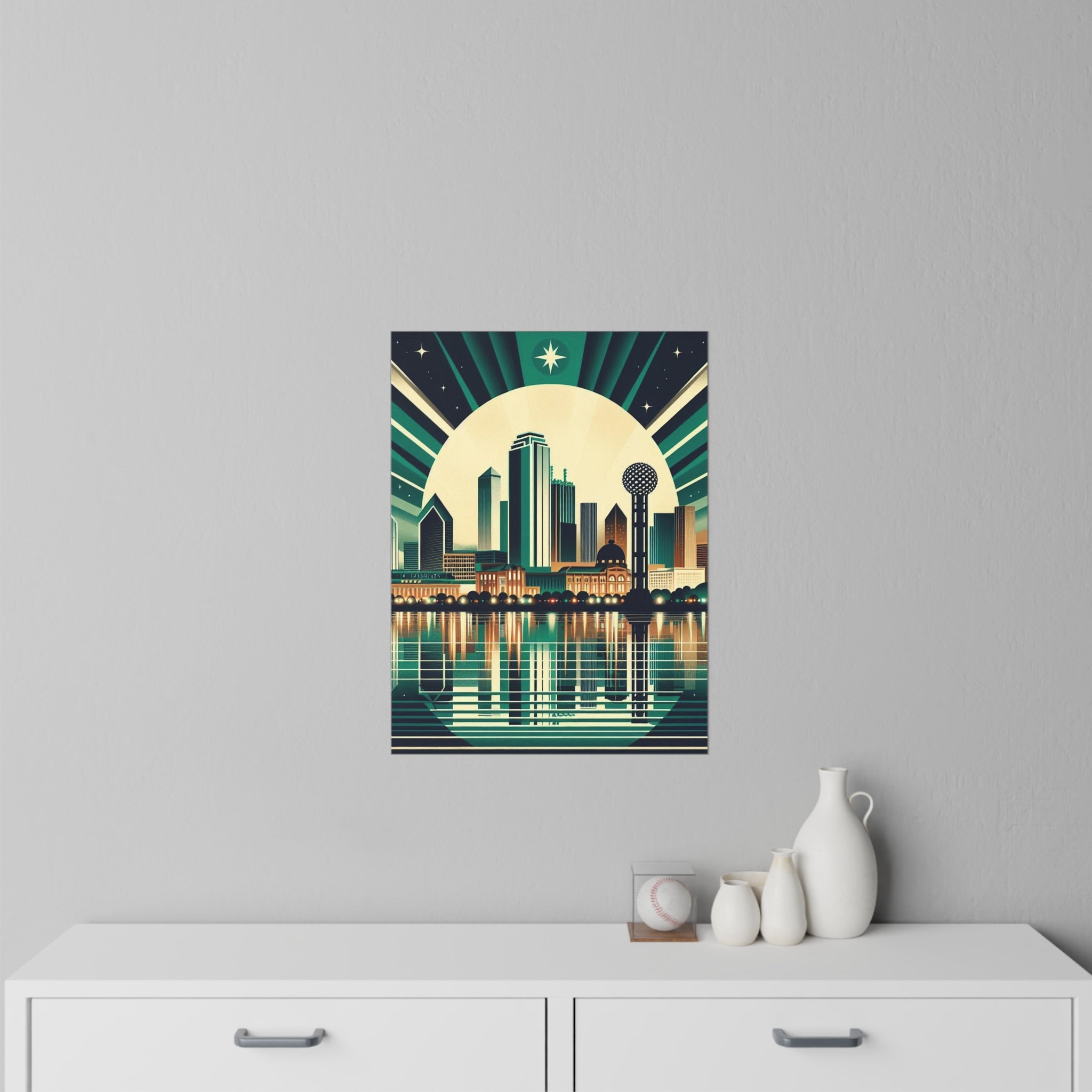 Poster of a city skyline with a moonlit sky on a gray wall above a white cabinet.