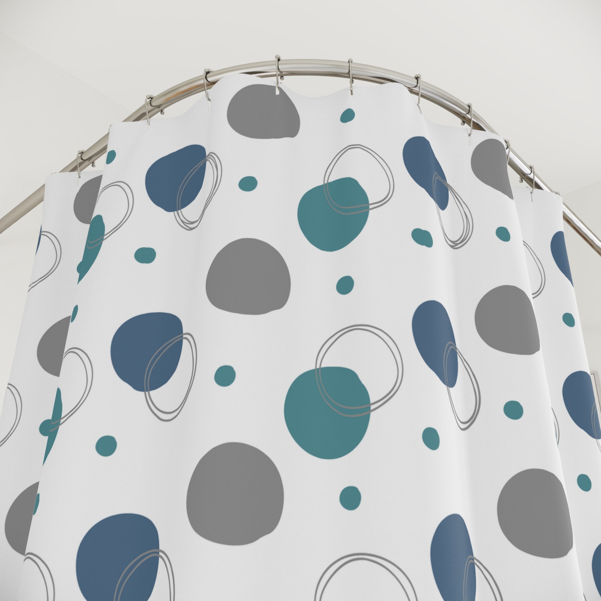Shower curtain with blue, gray, and green abstract pattern on a white background