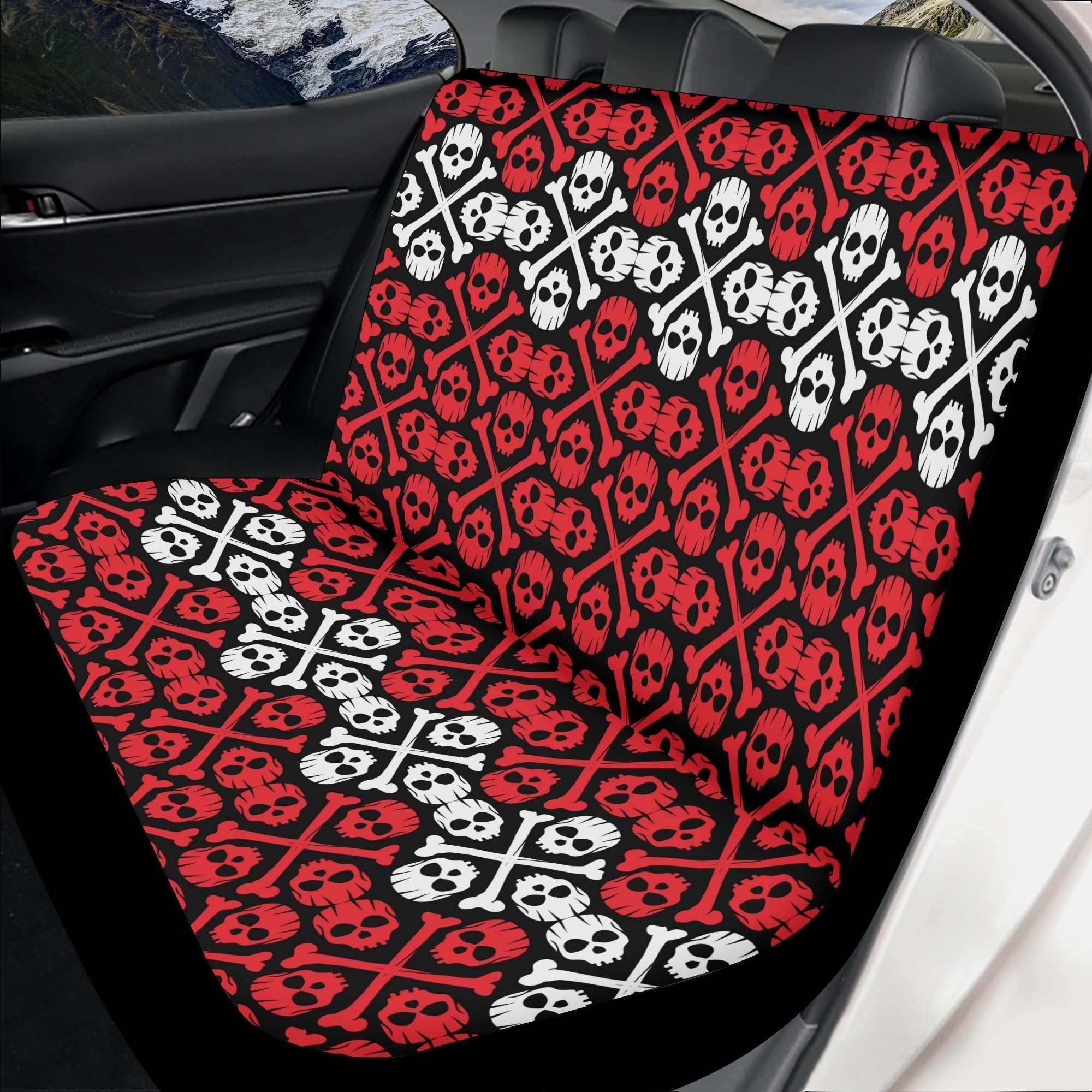 Car seat cover with skull and crossbones pattern in a vehicle.