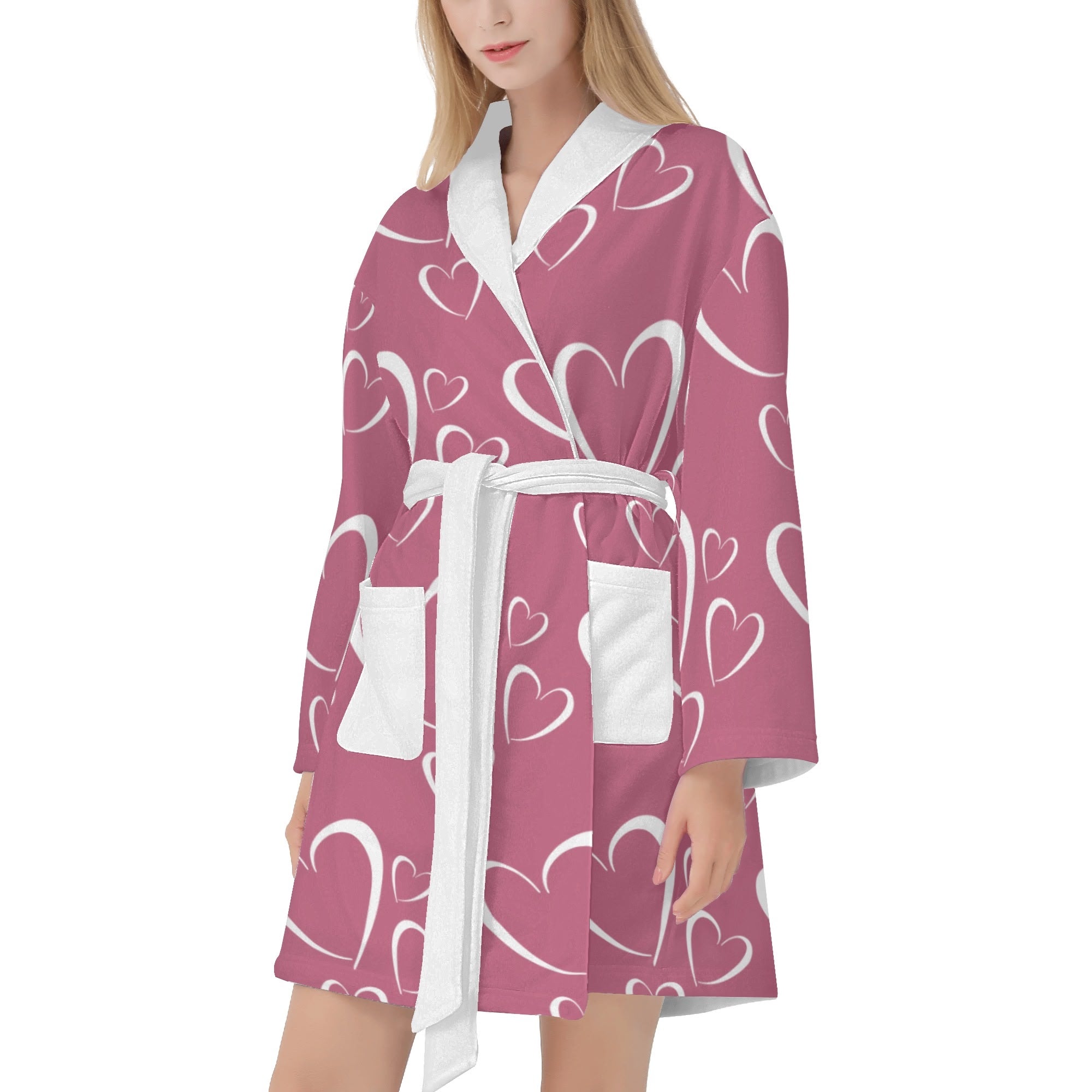 Woman wearing a pink robe with heart patterns on a white background