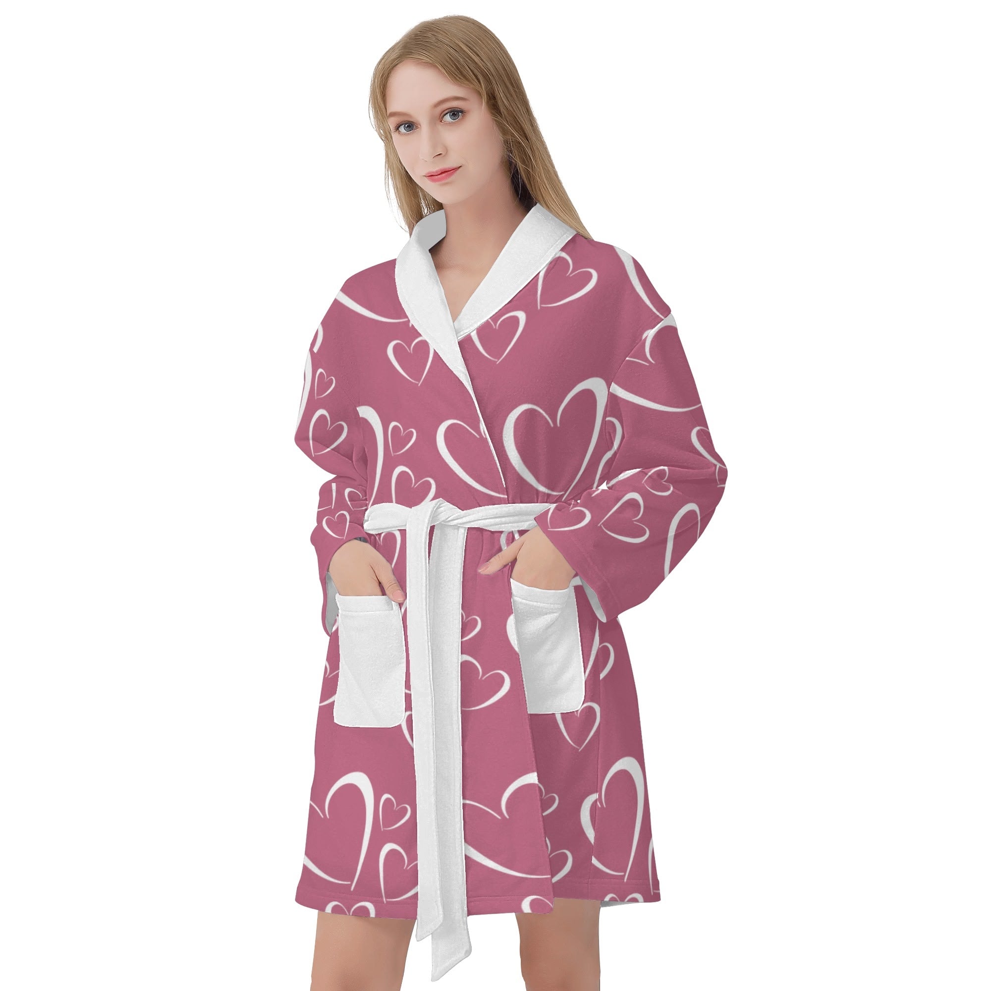 Woman wearing a pink robe with heart patterns on a white background