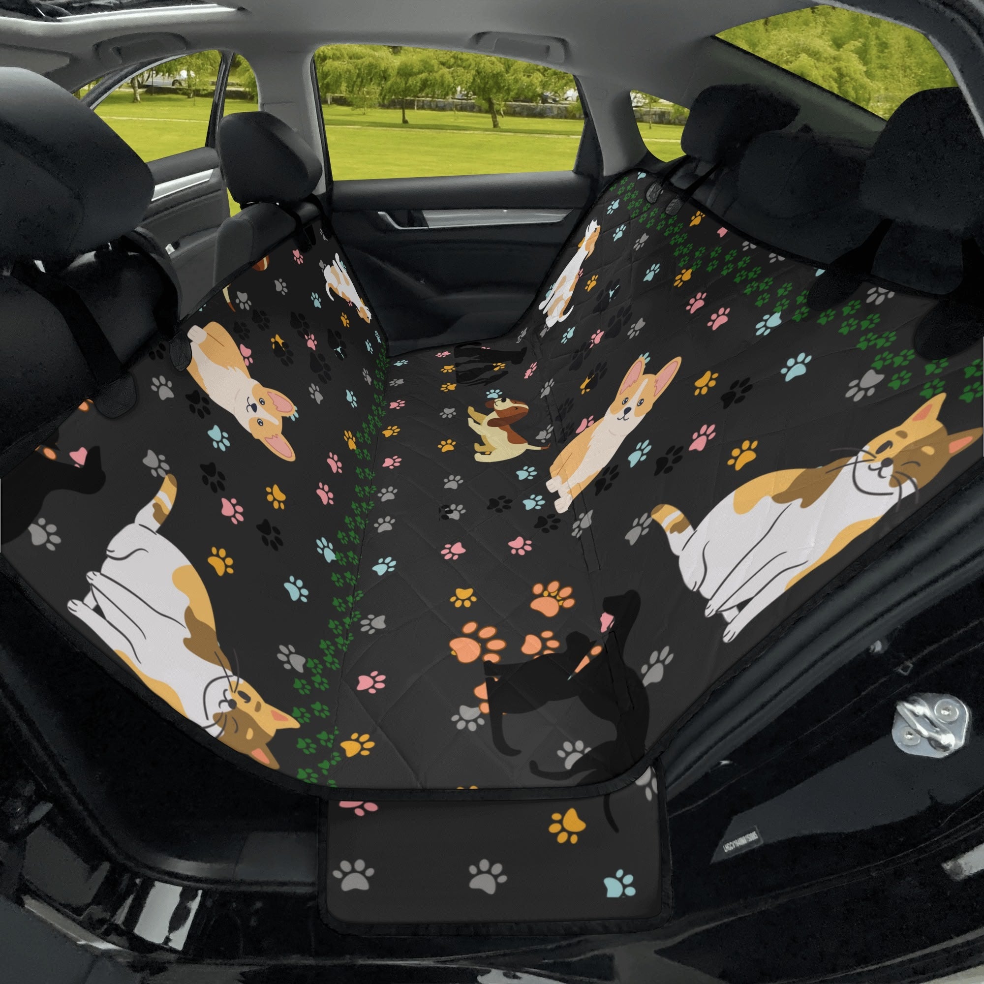 Car seat cover with corgi pattern and paw prints on a black background