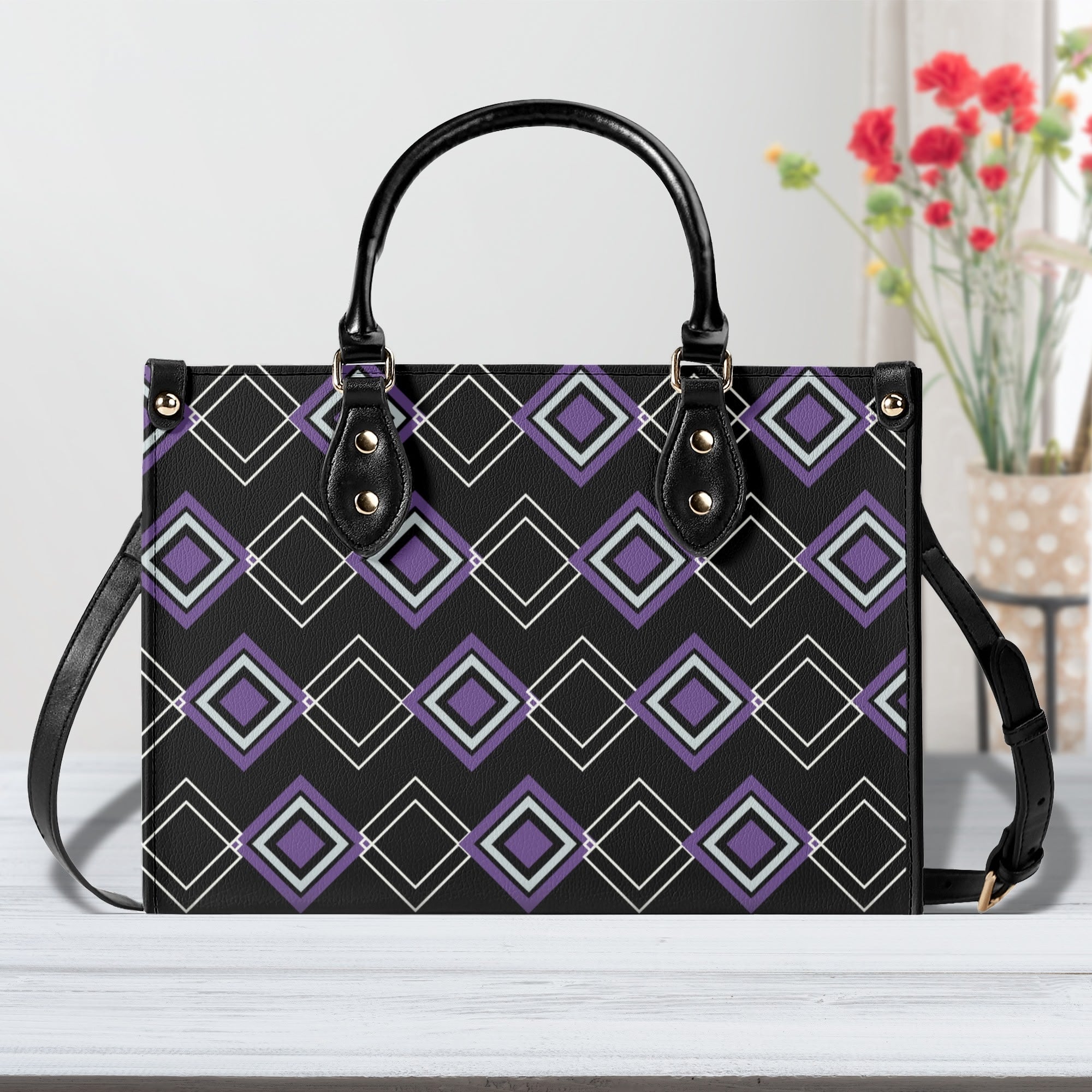 Handbag with geometric pattern on a white surface with flowers in the background