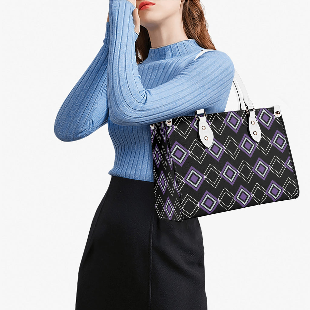 Person holding a patterned handbag against a white background
