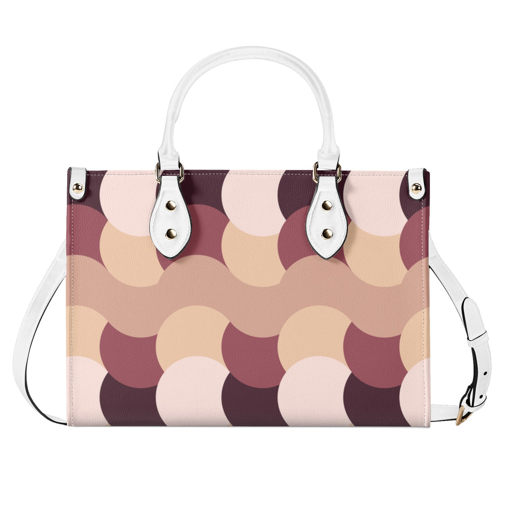 Patterned handbag with white handles and strap on a white background
