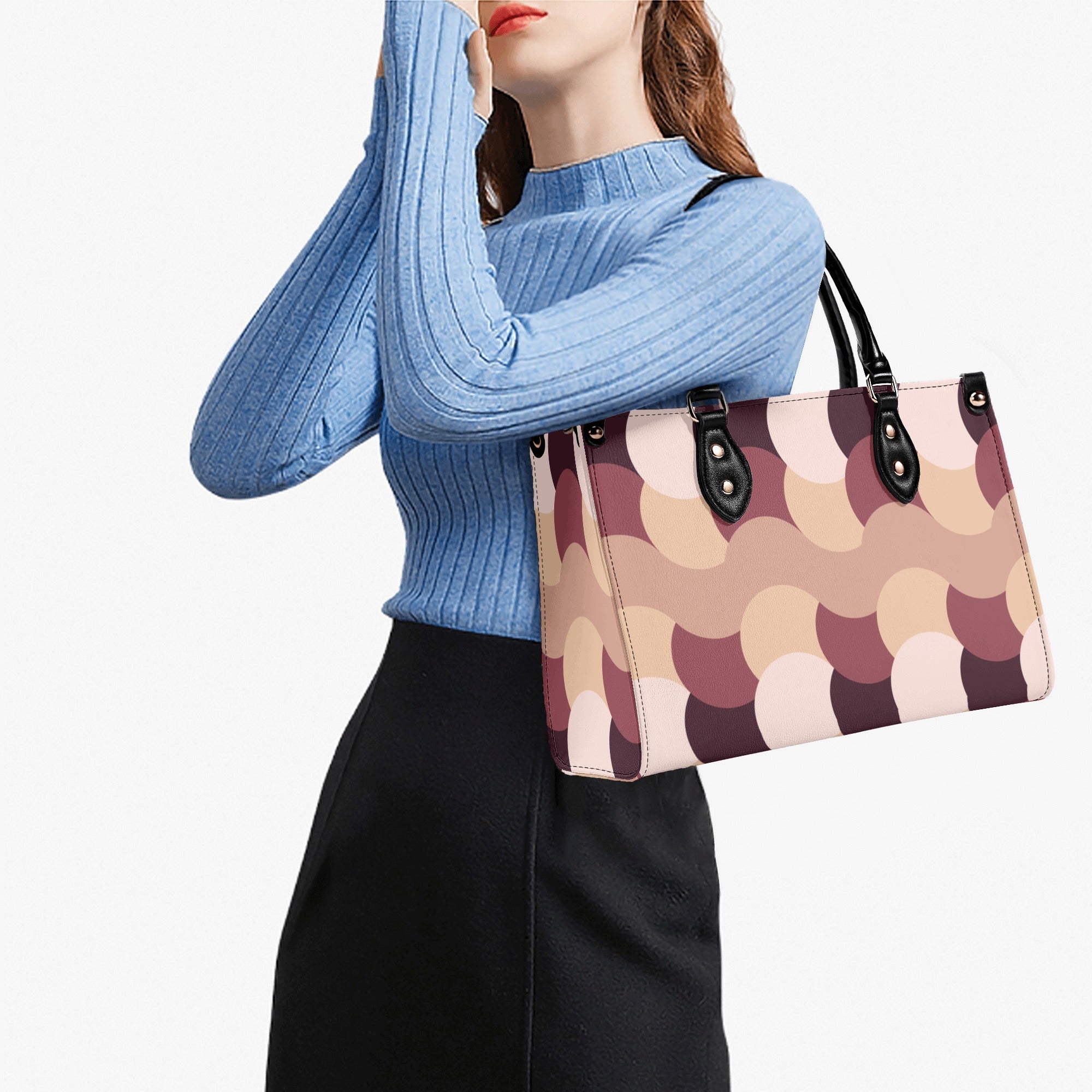Woman holding a patterned handbag against a white background