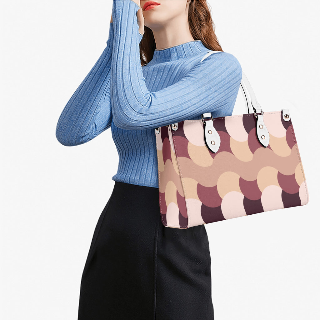 Woman holding a patterned handbag against a white background