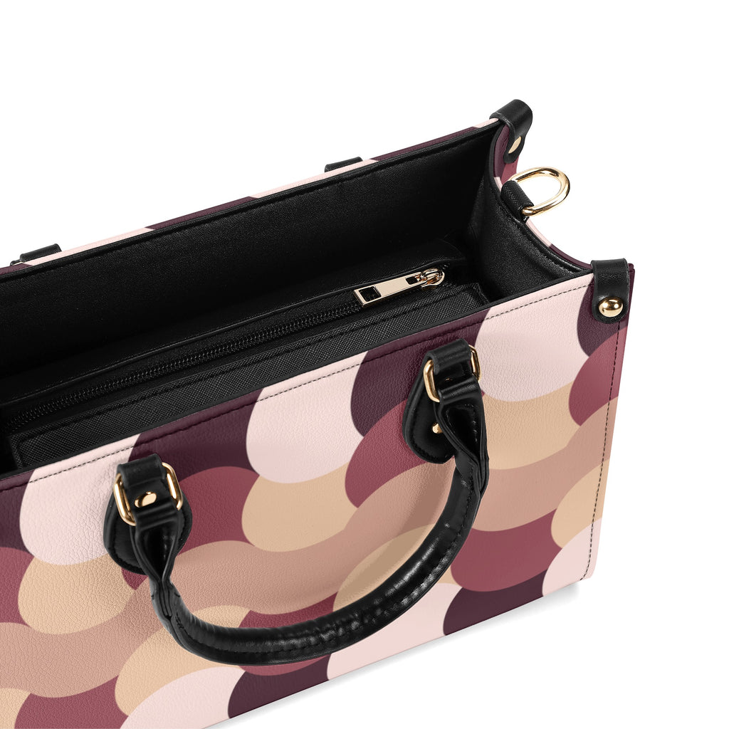 Patterned handbag with black handle and trim on a white background