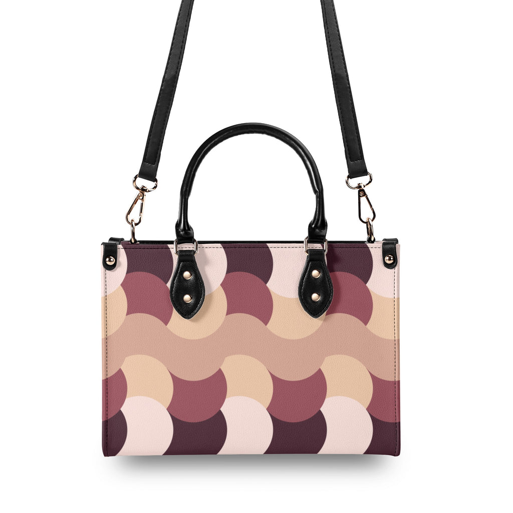 Handbag with circular pattern and black handles on a white background