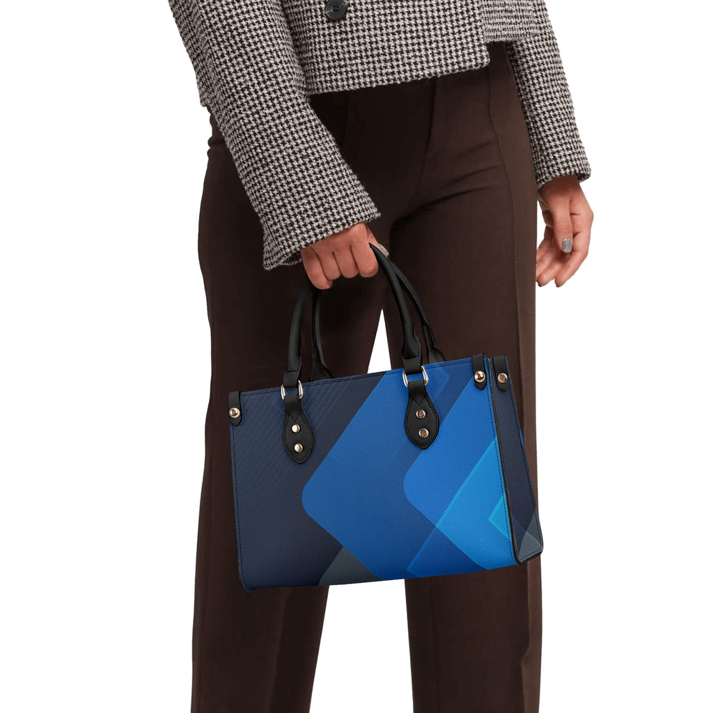 Person holding a blue geometric-patterned handbag against a white background