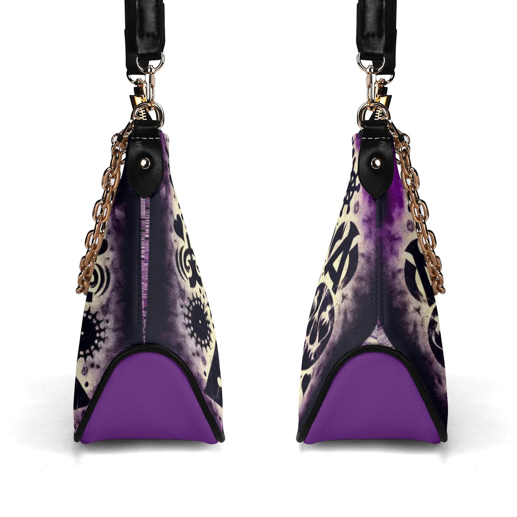 Purple and black handbag with decorative patterns on a white background