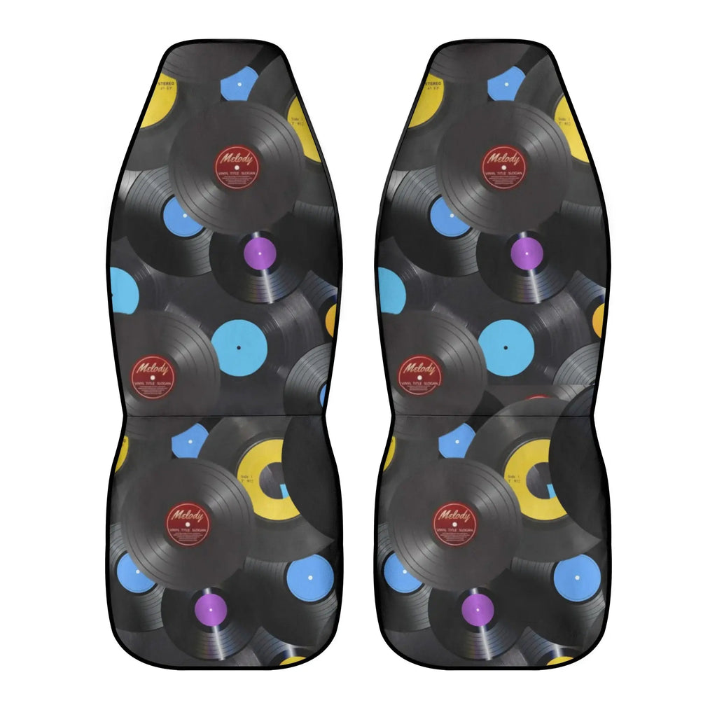 Pair of car seat covers with vinyl record design on a white background
