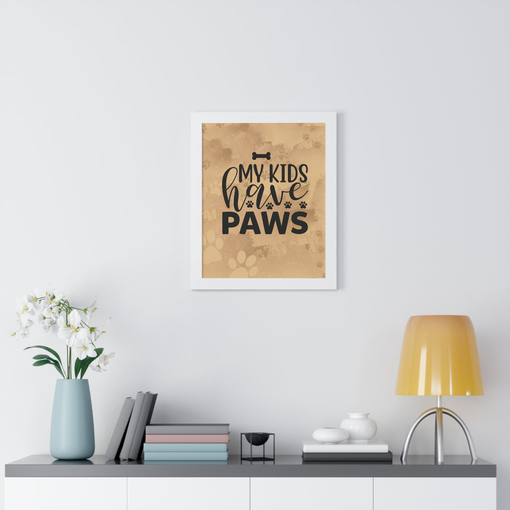 Framed print with 'My kids have paws' text on a wall above a desk with decor items.