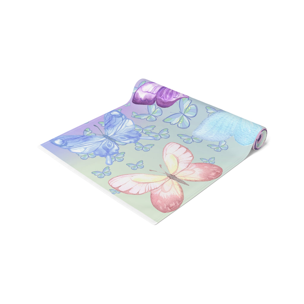 Yoga mat with butterfly design and purple ribbon on a white background