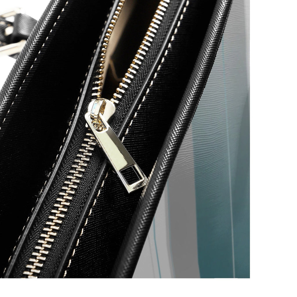 Close-up of a black suitcase with gold zipper pull