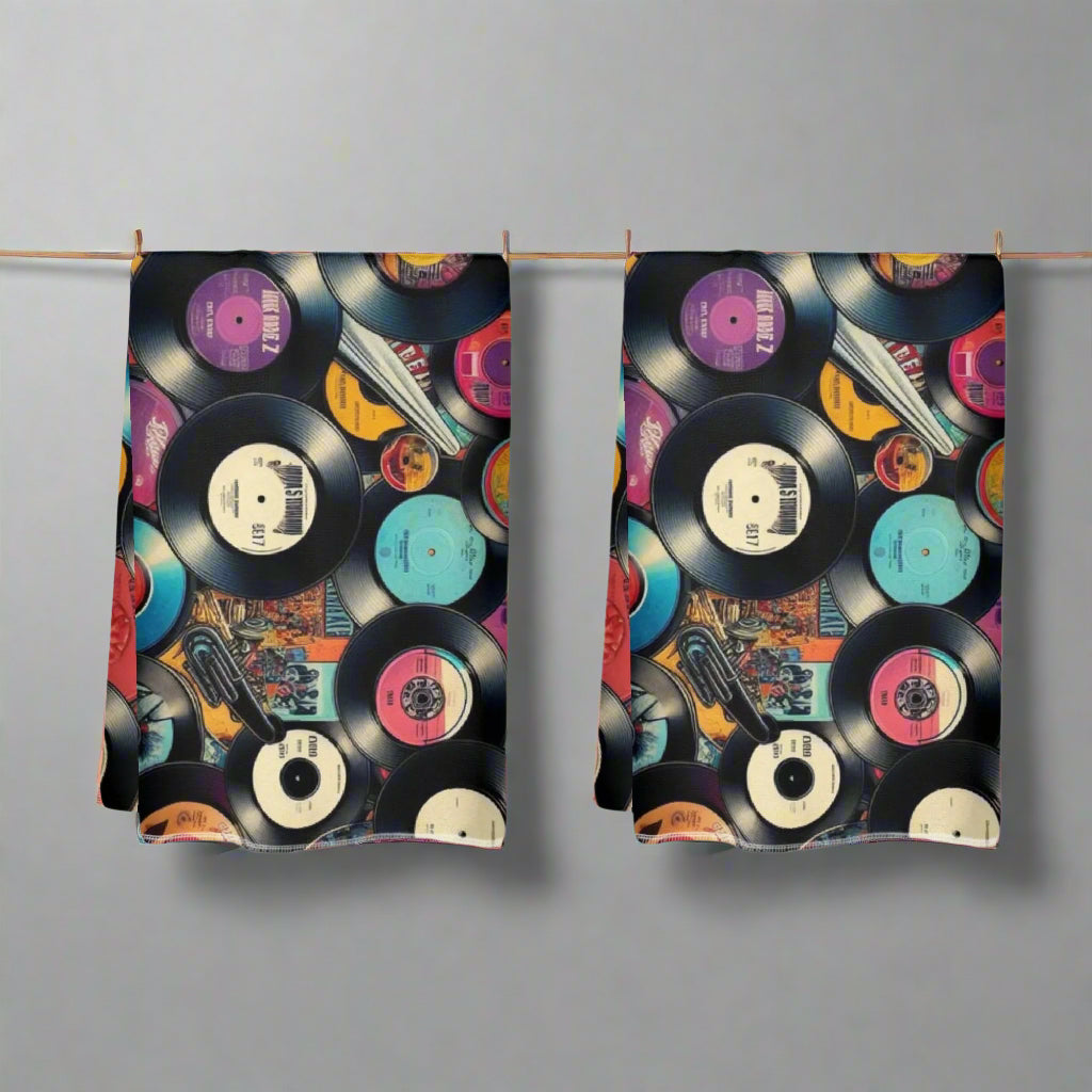 Pair of kitchen towels with vinyl record design on a white background