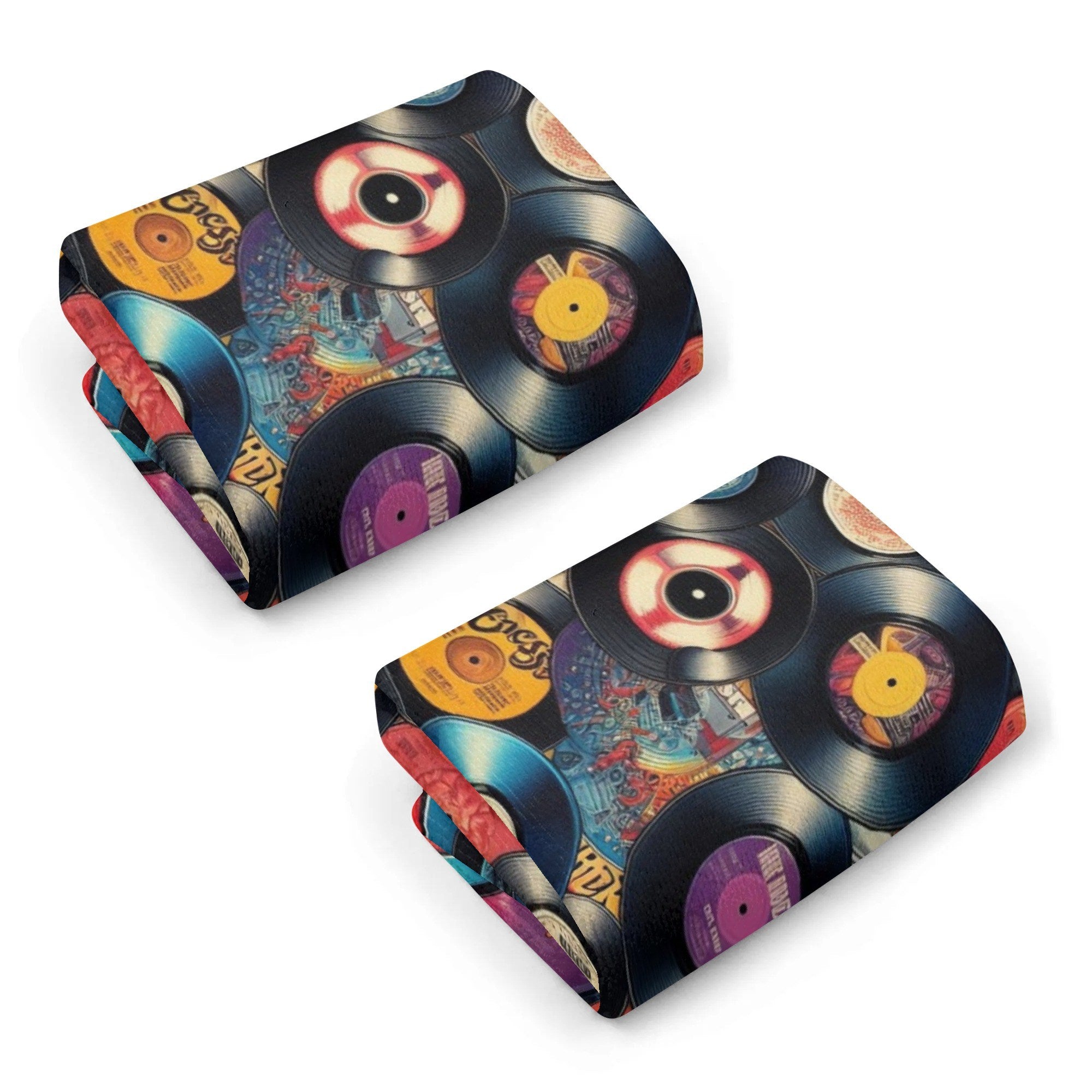 Two folded kitchen towels with vinyl record design on a white background