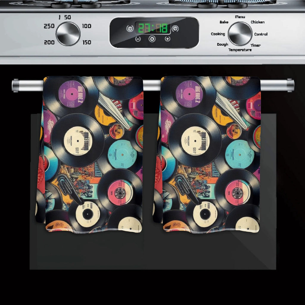 Towel with vinyl record design hanging on a stove handle