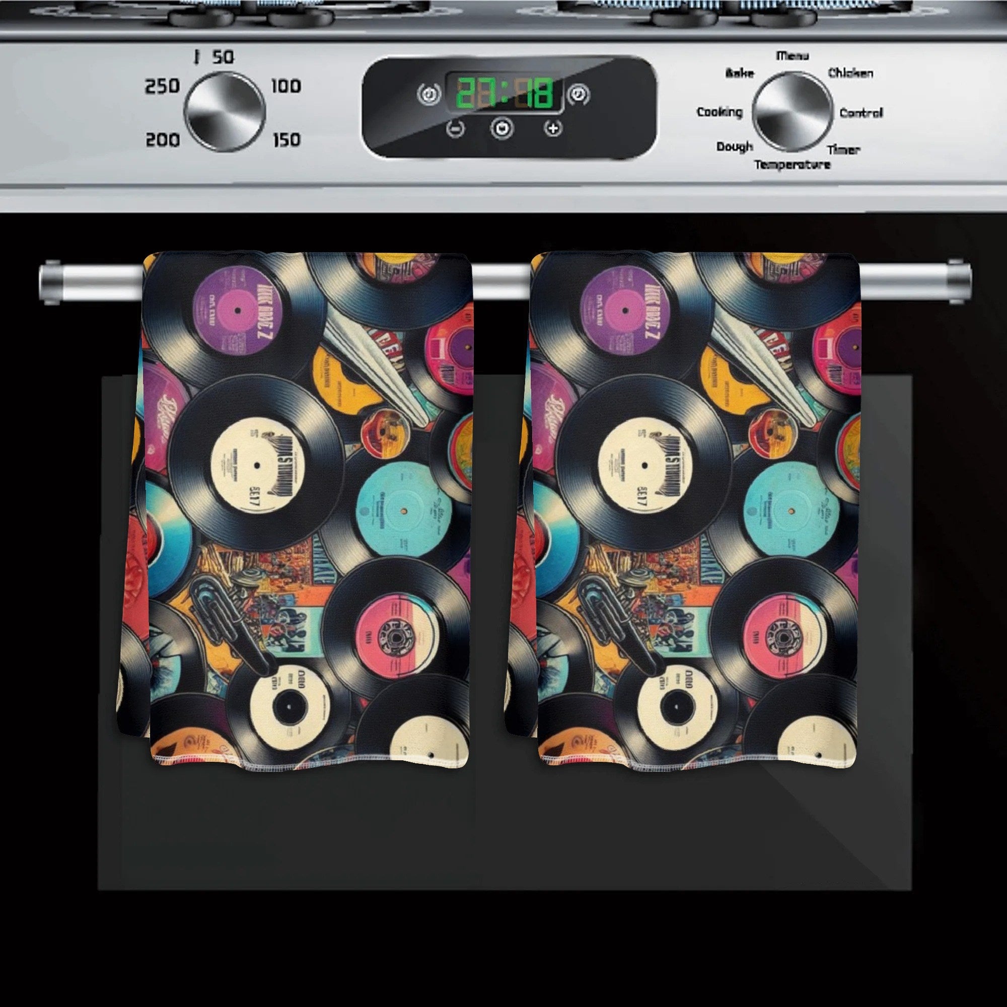 Towel with vinyl record design hanging on a stove handle
