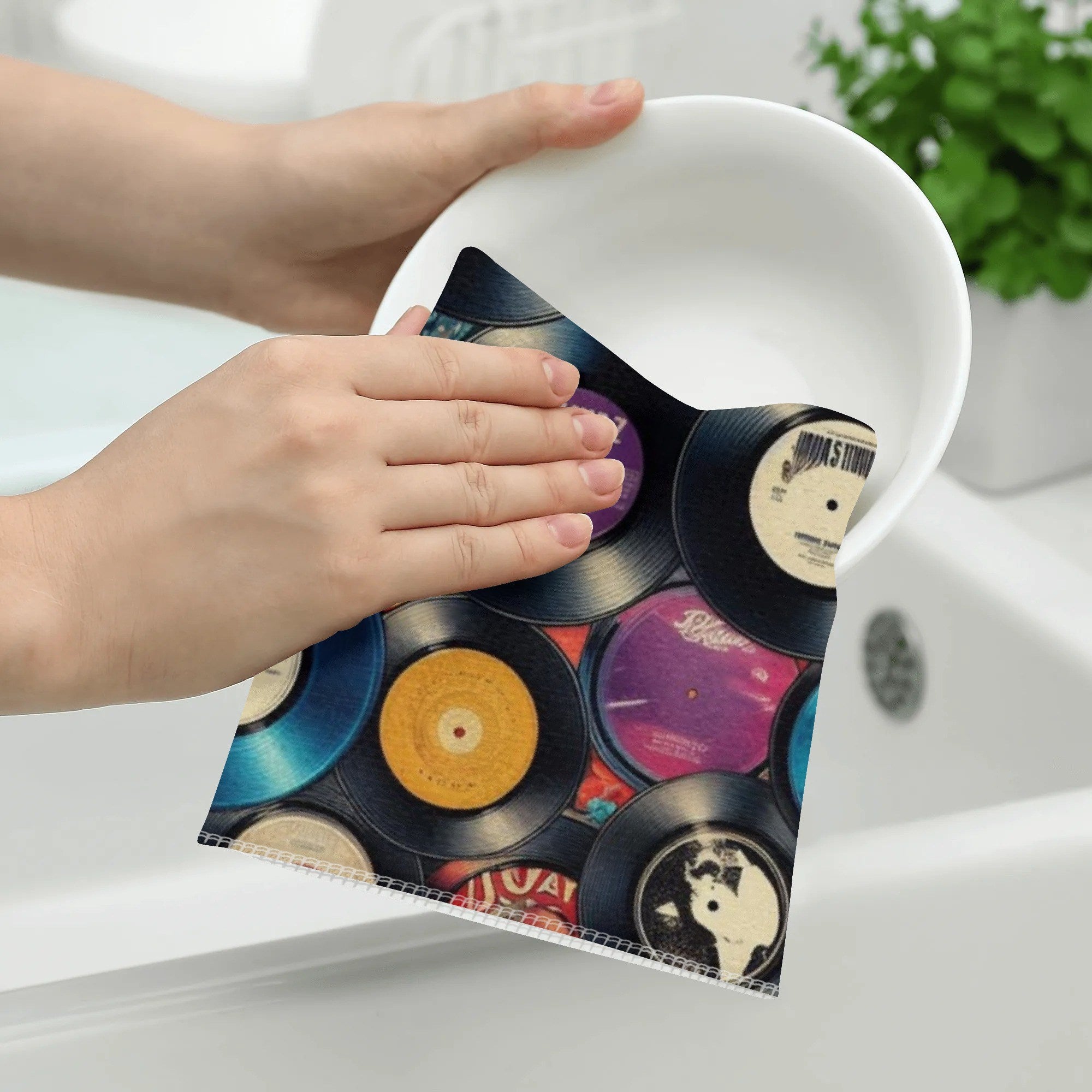 Person holding a decorative plate with vinyl record design