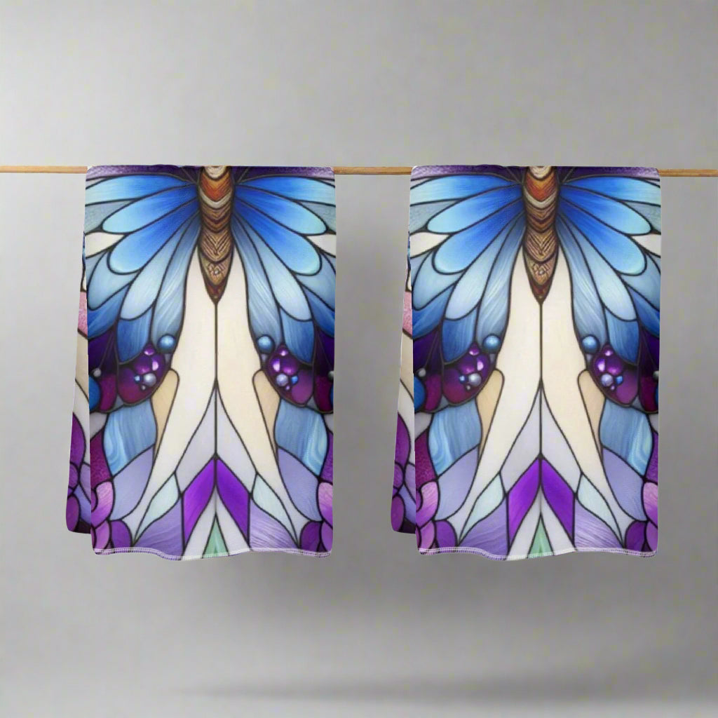 Pair of butterfly-themed kitchen towels with blue, purple, and white design on a white background
