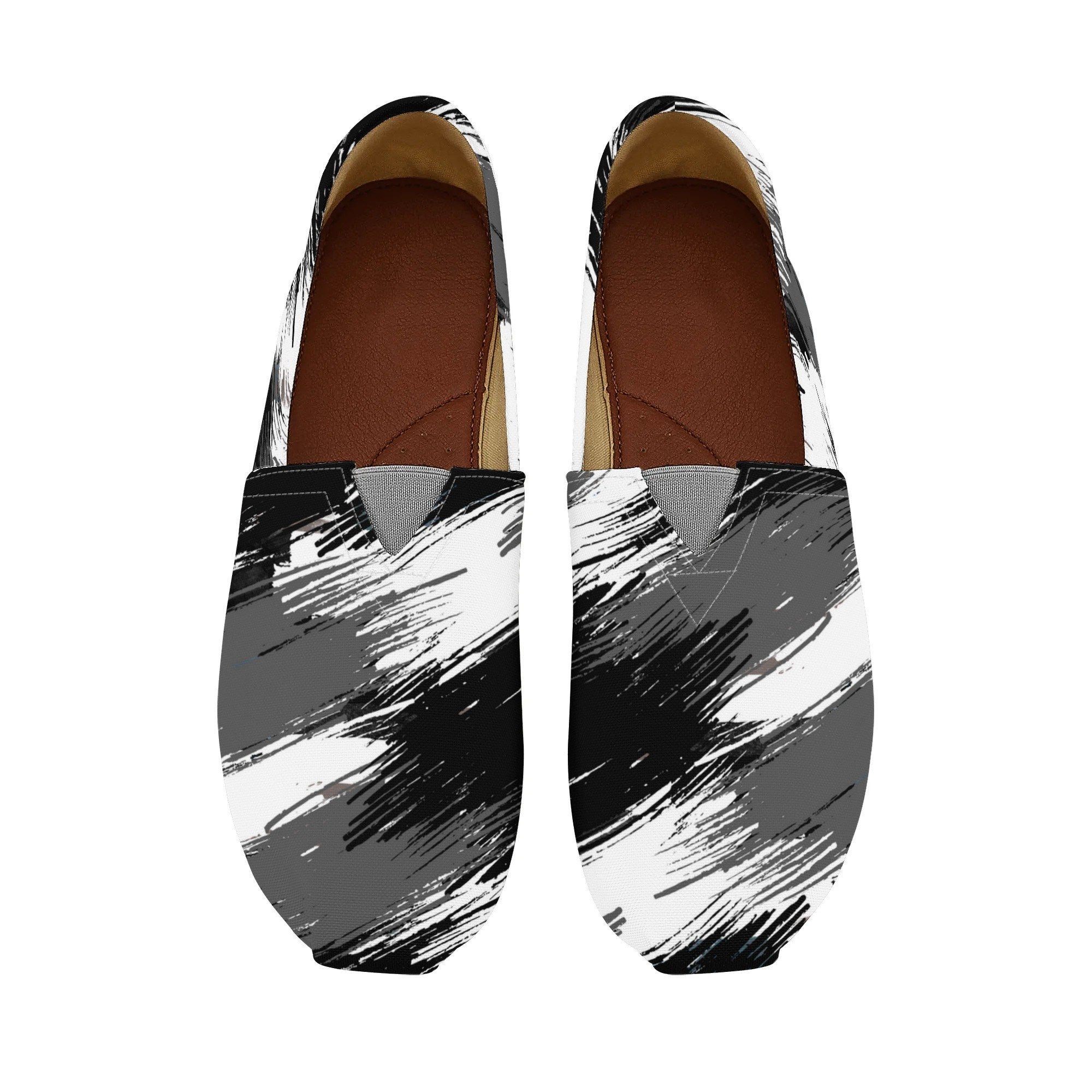 Pair of black, white, and gray abstract-patterned shoes on a white background