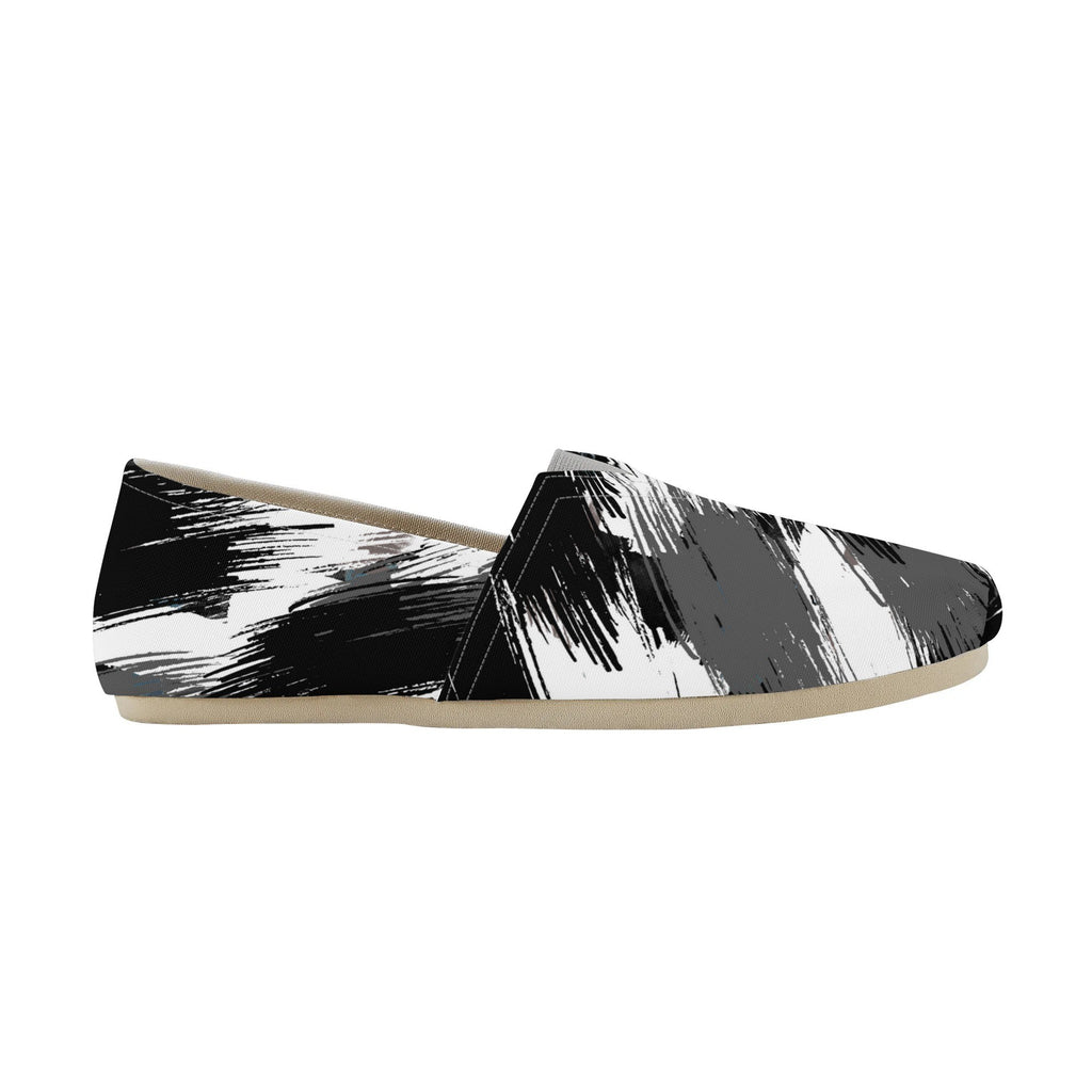 Black and white abstract patterned flat shoes on a white background