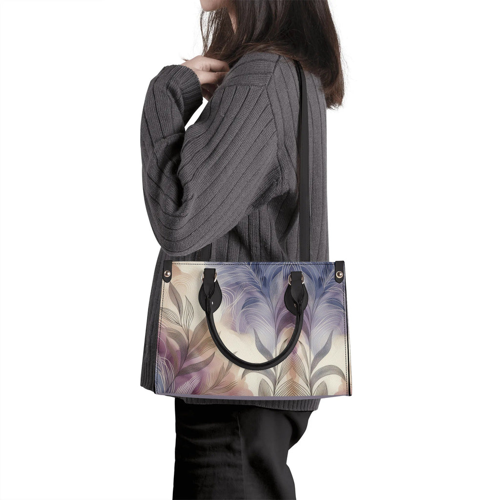 Person wearing a gray sweater with a floral-patterned handbag.