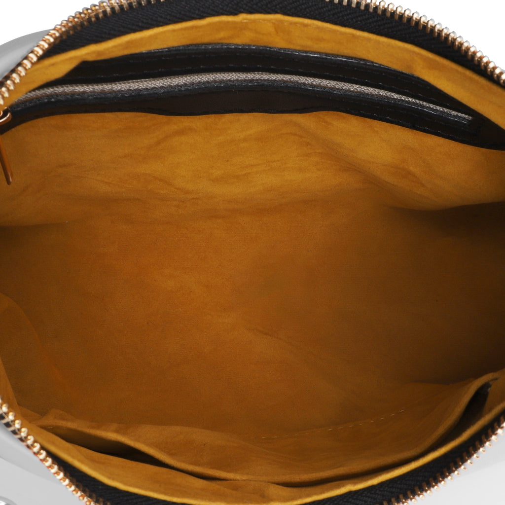 Close-up of a brown leather bag interior with a zipper.