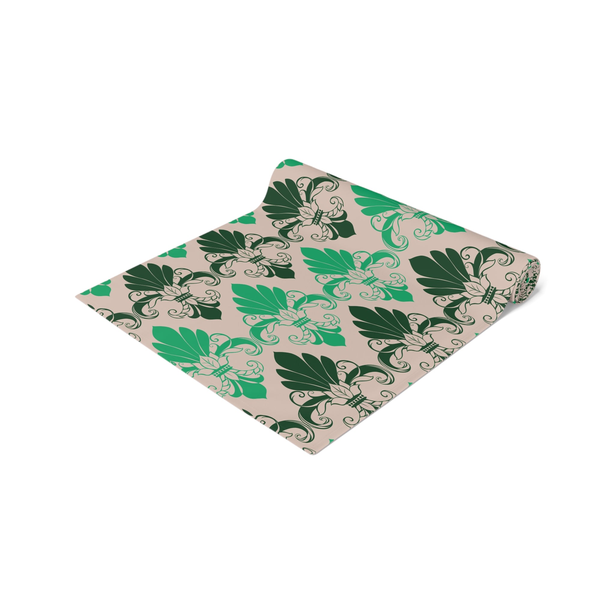 Folded fabric with green leaf pattern on a beige background
