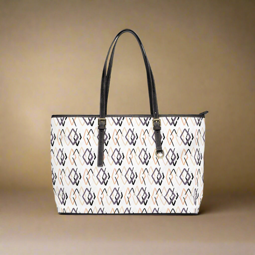 Patterned handbag with black handles on a white background