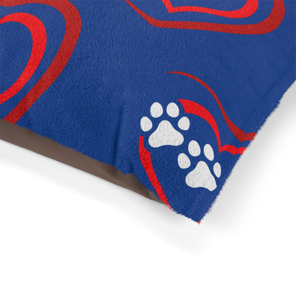 Blue rug with red patterns and white paw prints on a white background