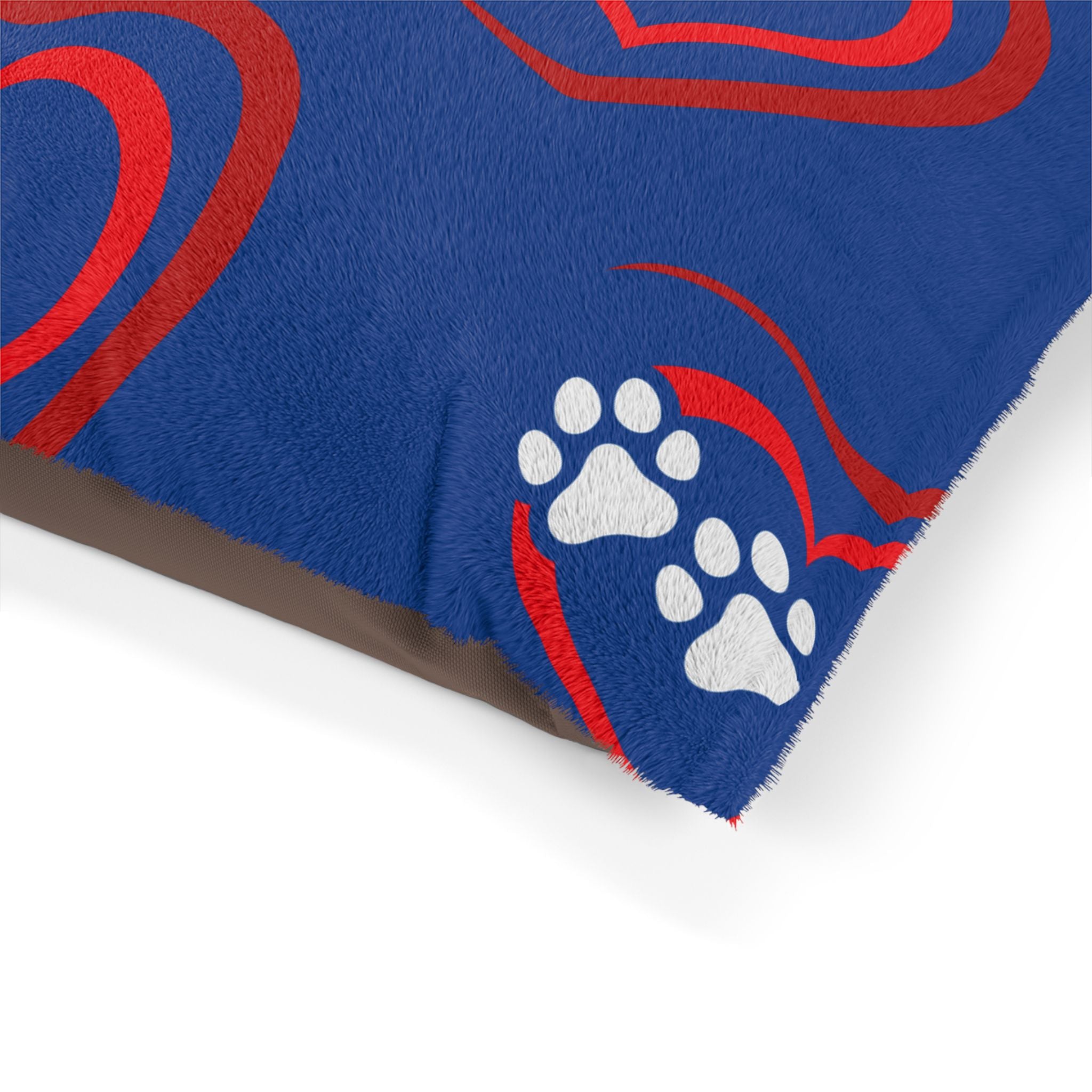 Blue rug with red patterns and white paw prints on a white background