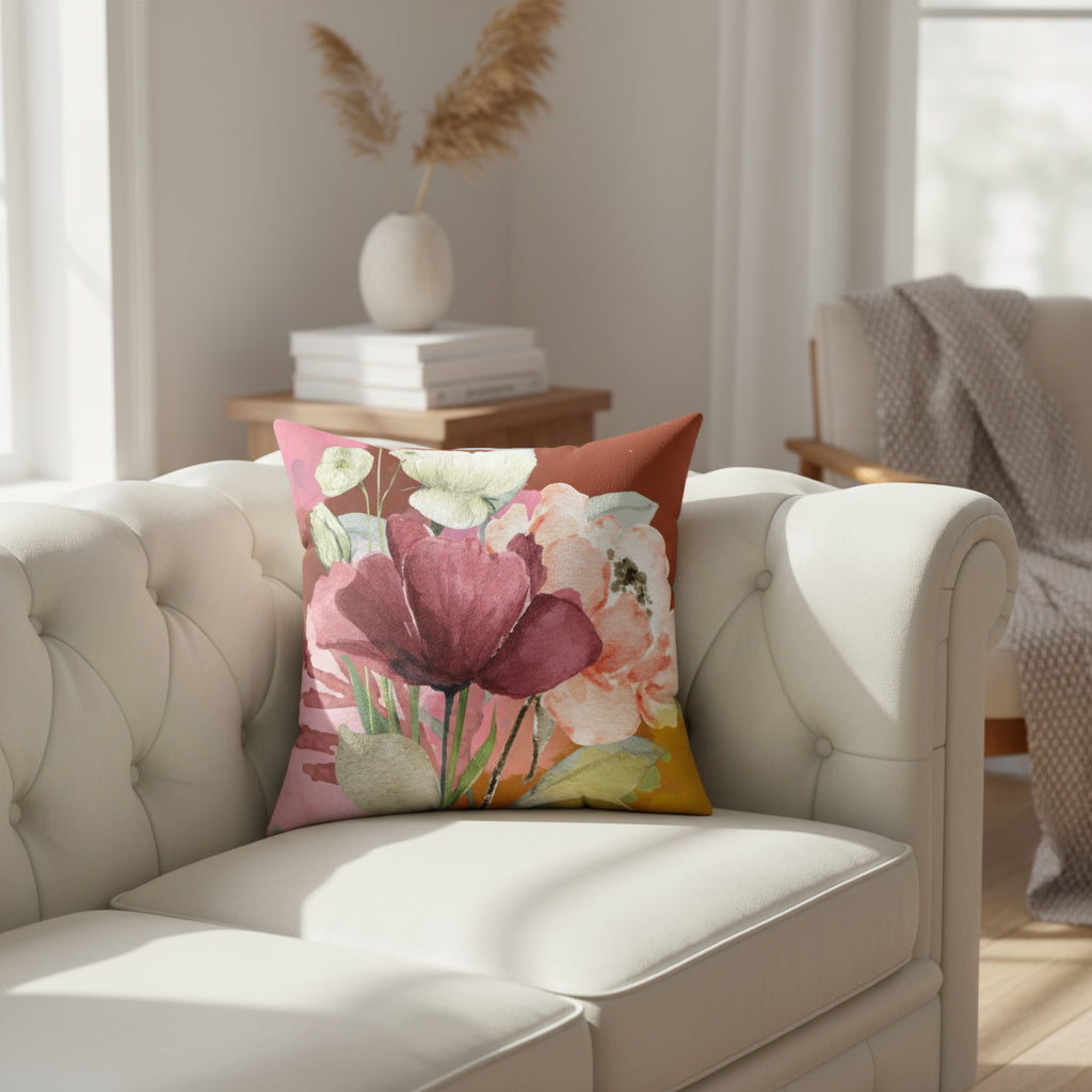 Floral-patterned pillow with pink, red, and green colors on a white background