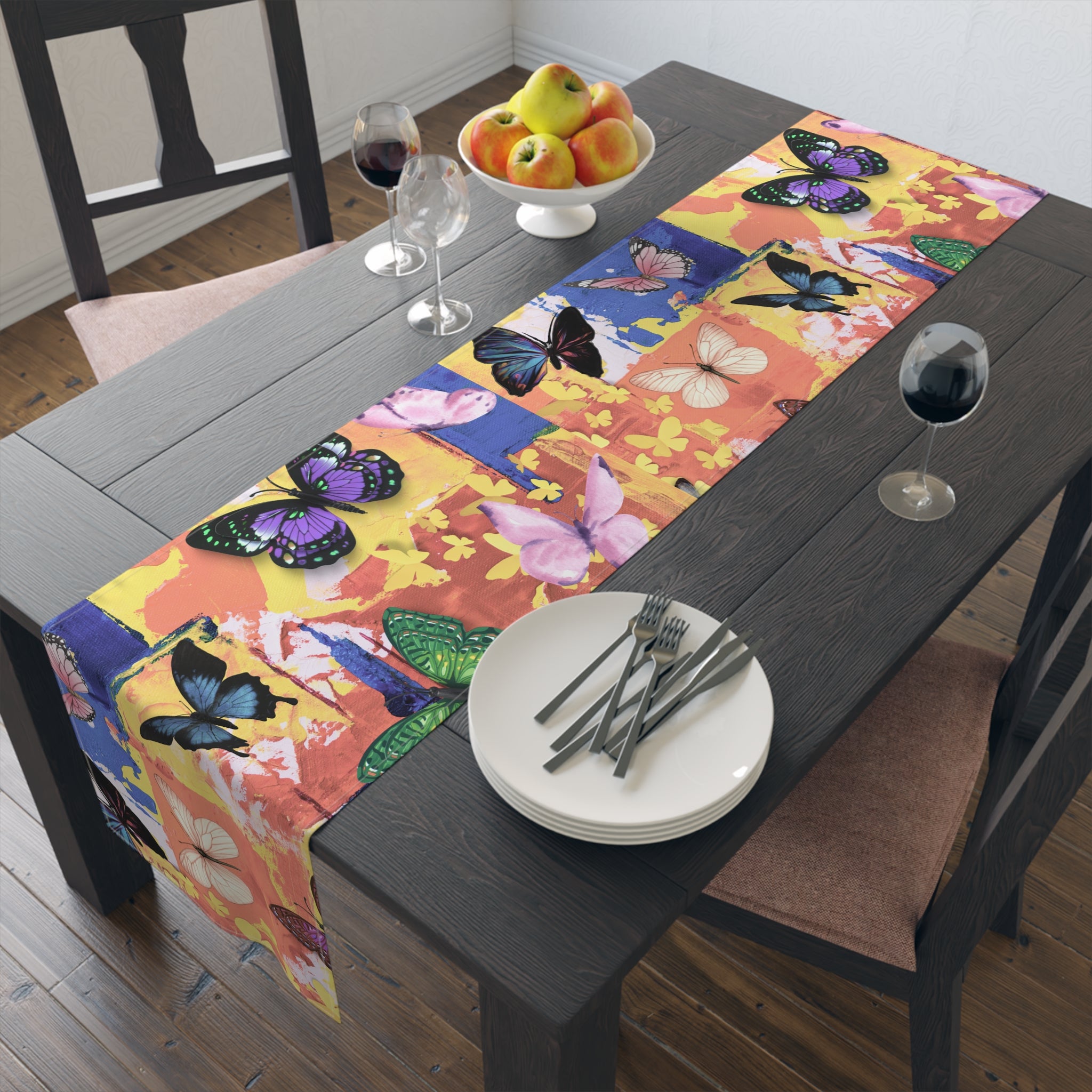 Dining table with a colorful butterfly-patterned table runner, plates, and cutlery.