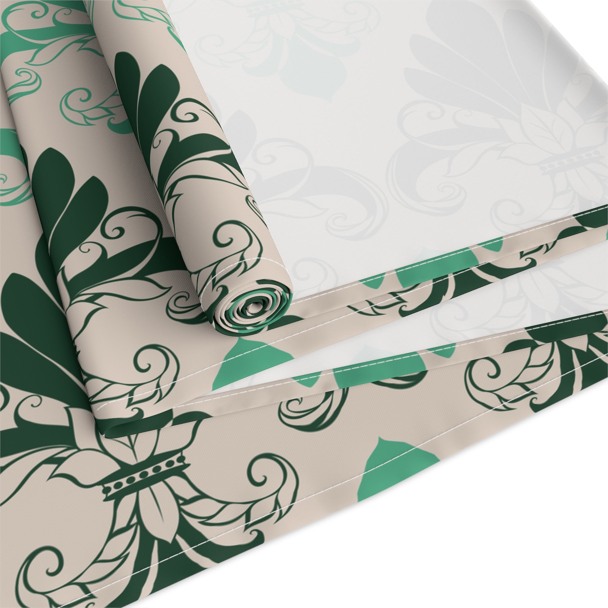 Roll of green and beige patterned paper on a white background