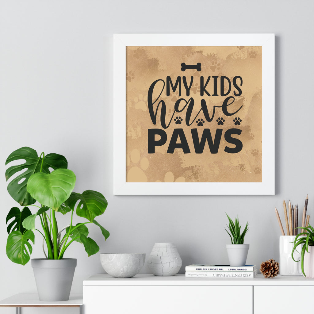 Framed print with 'My kids have paws' text on a wall with decorative items below.