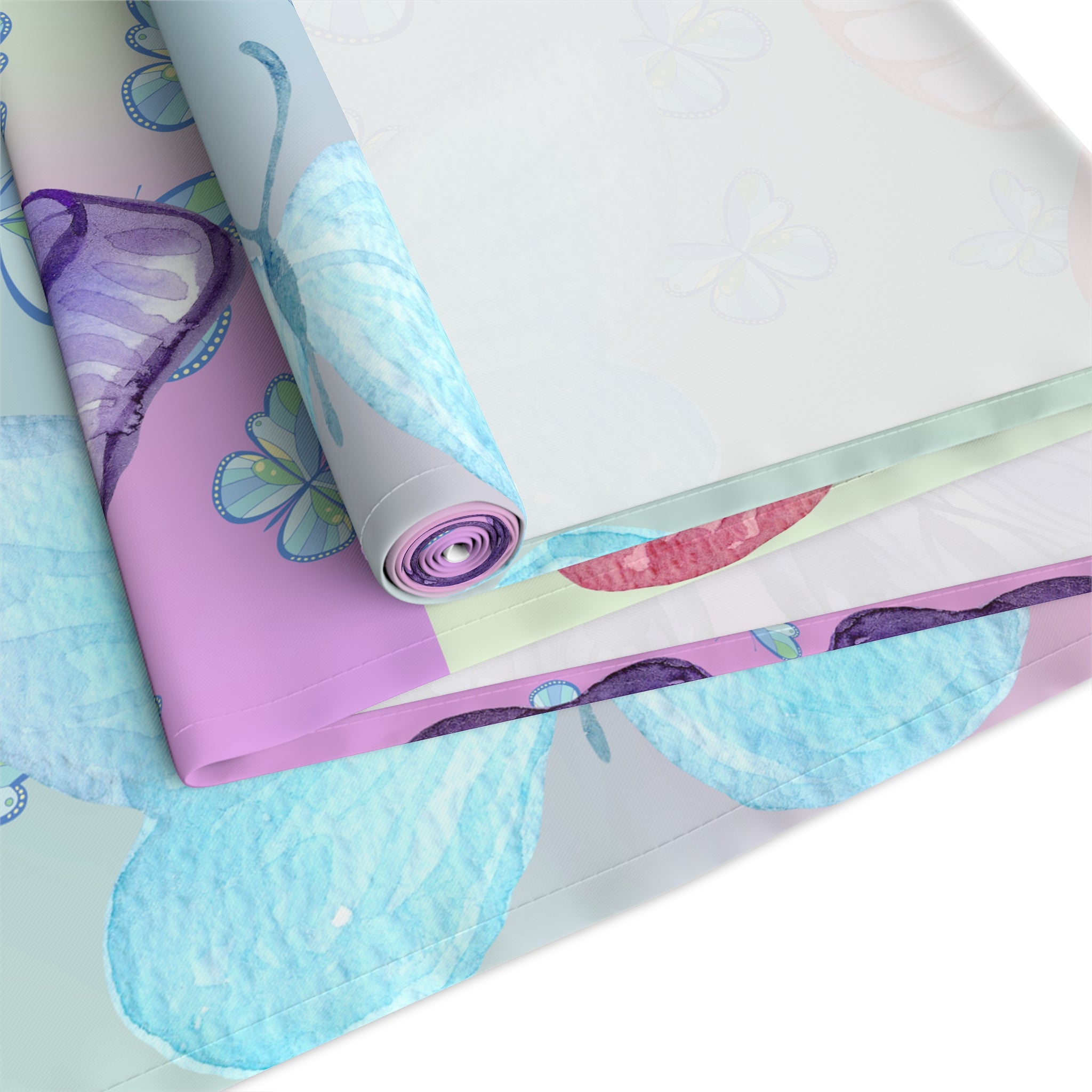 Rolls of colorful fabric with butterfly patterns on a white background