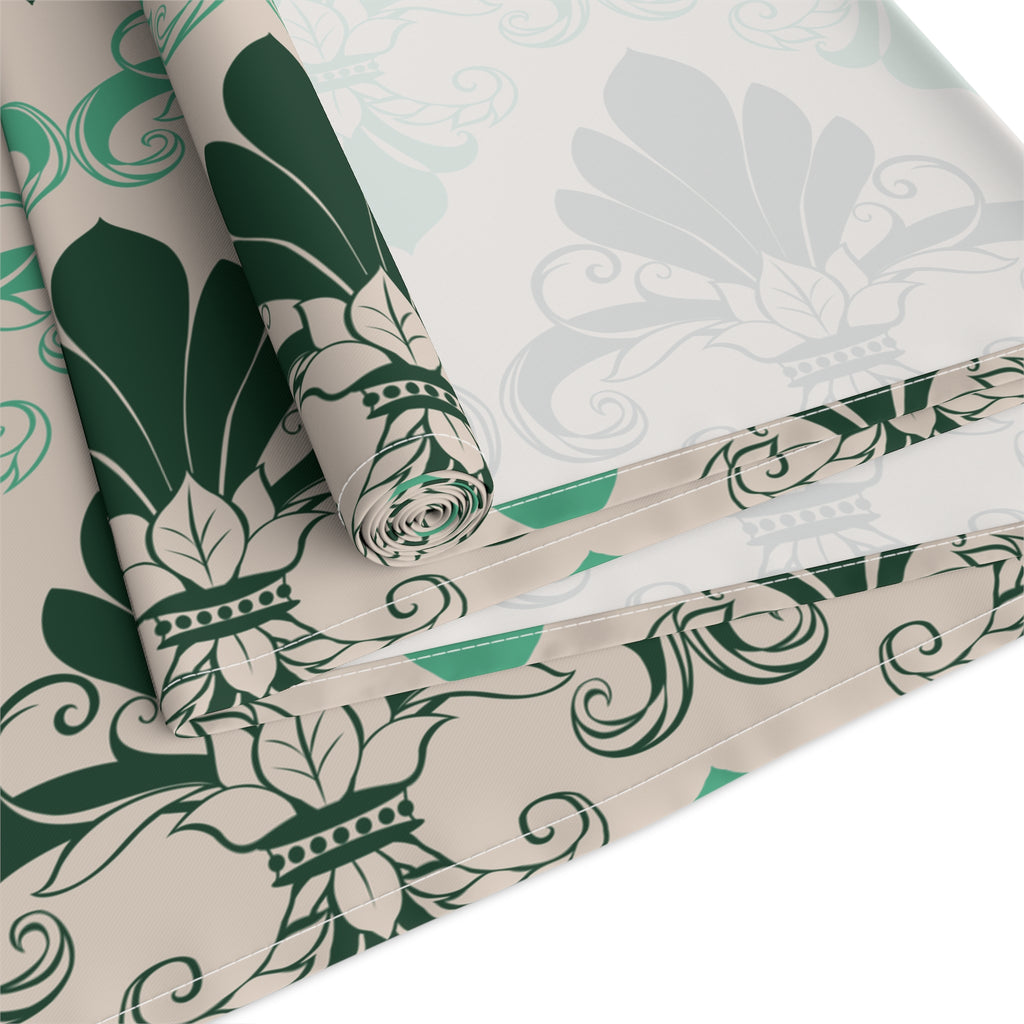 Roll of green and white floral patterned paper on a white background
