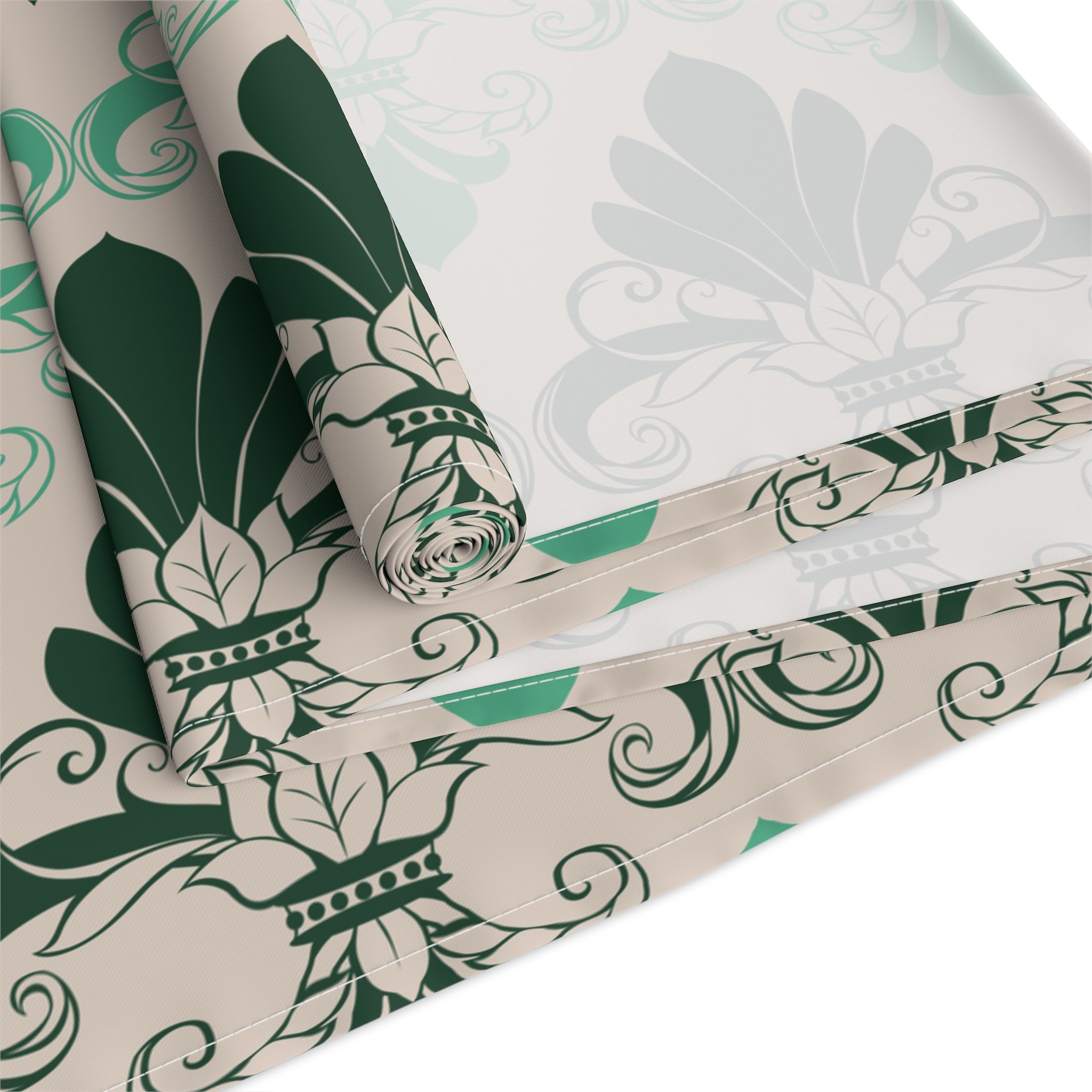 Roll of green and white floral patterned paper on a white background